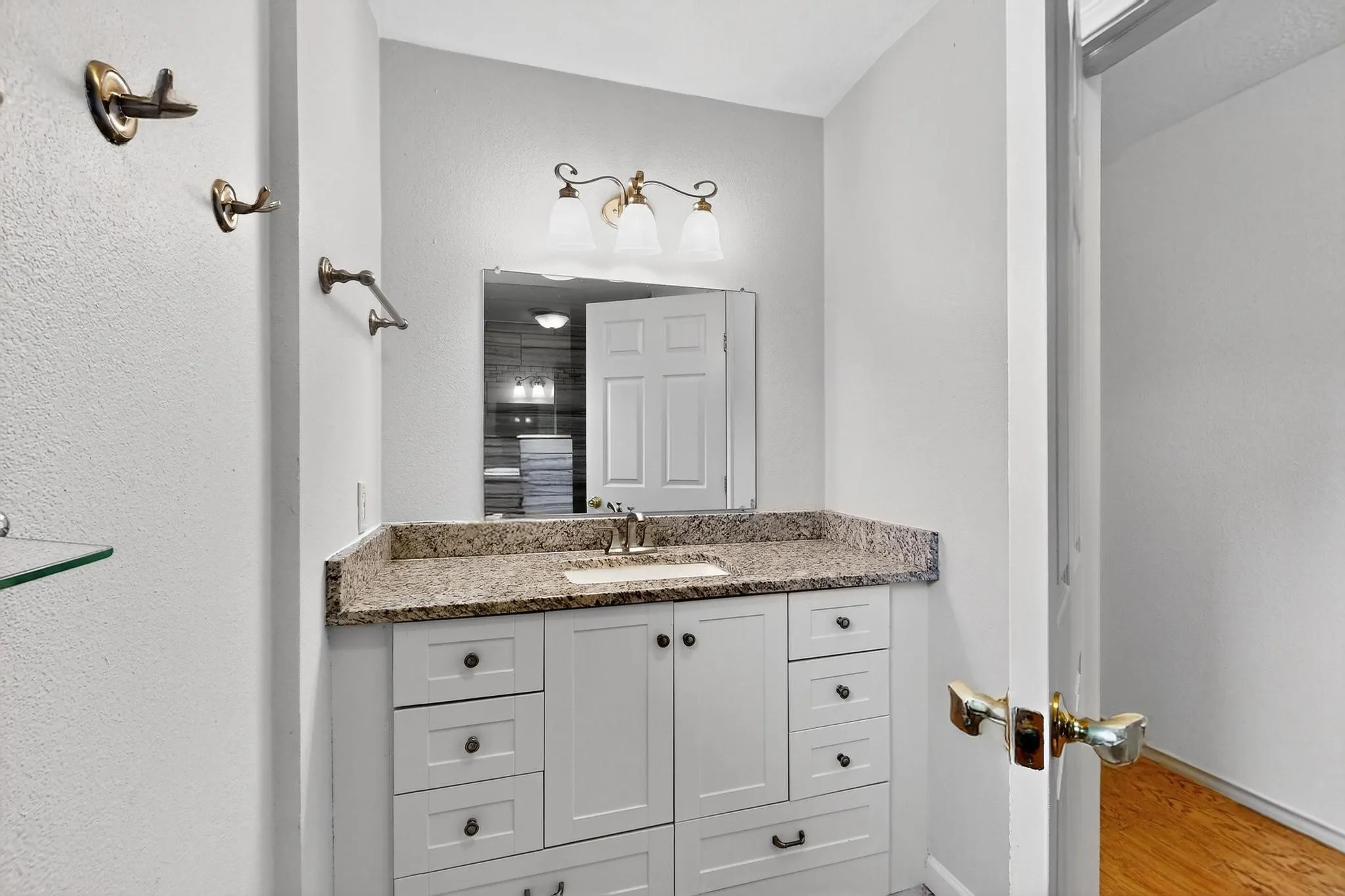 Bathroom featuring vanity and wood finished floors