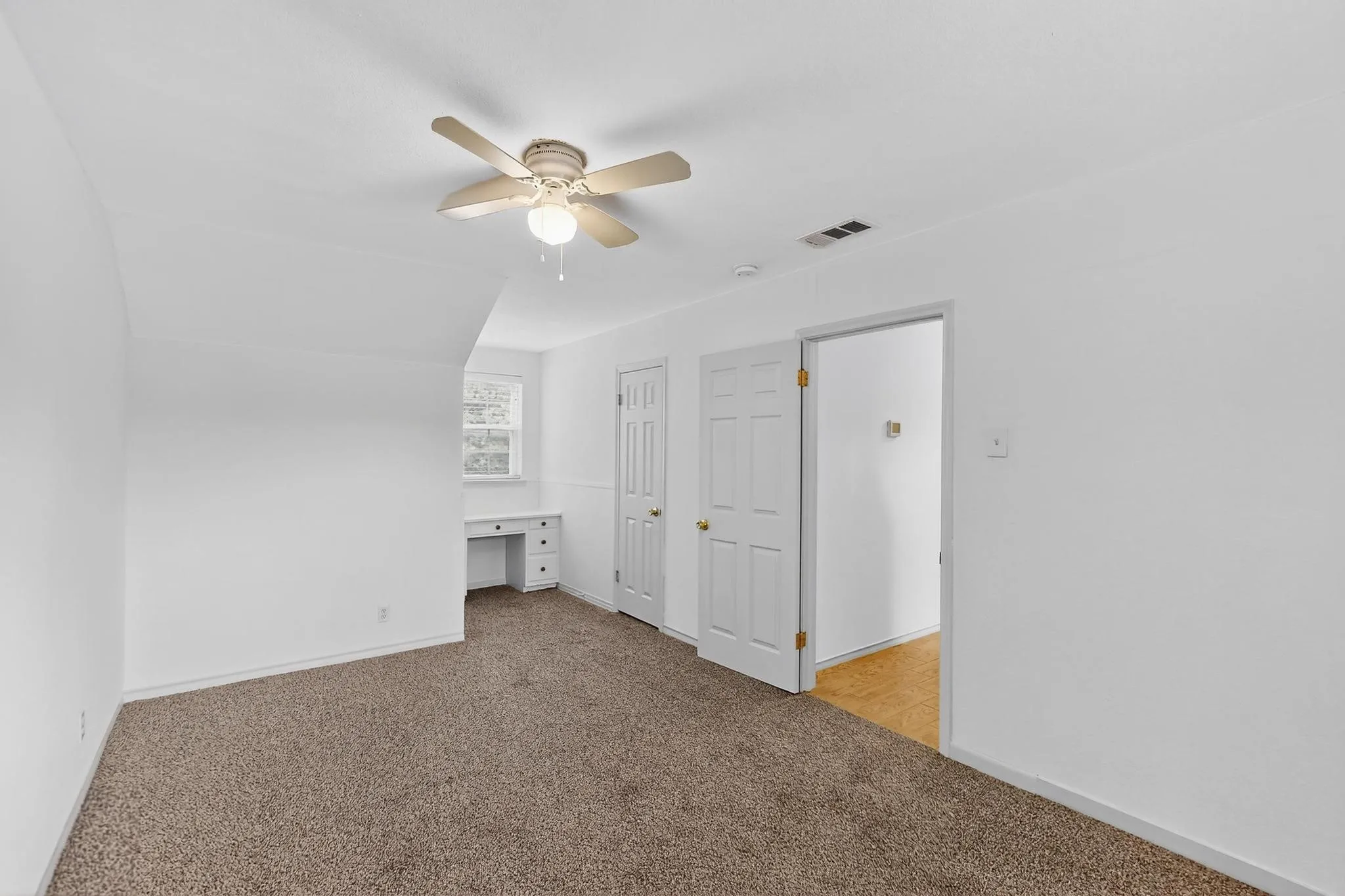 Bonus room featuring light colored carpet and ceiling fan