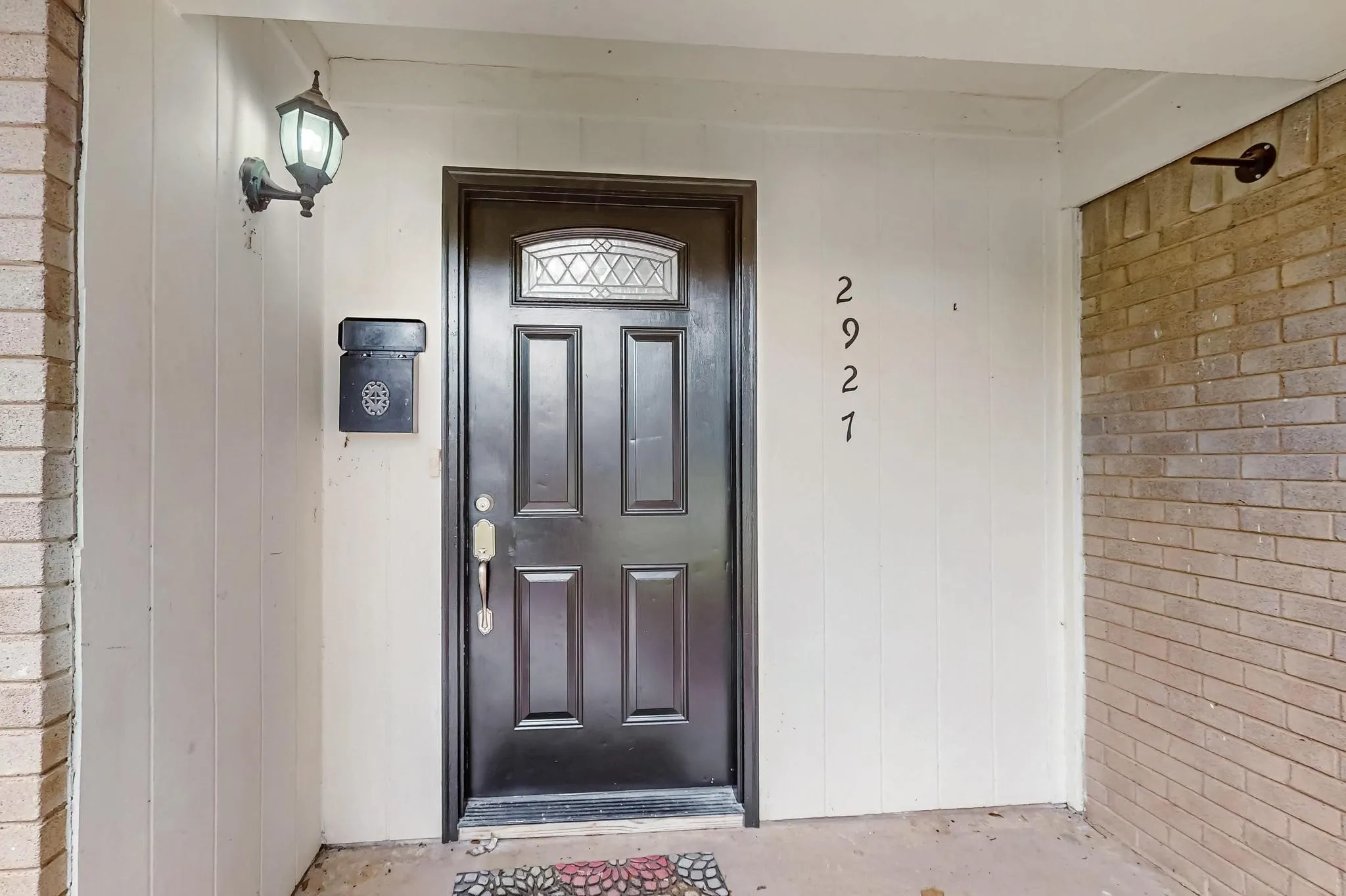 View of exterior entry featuring brick siding