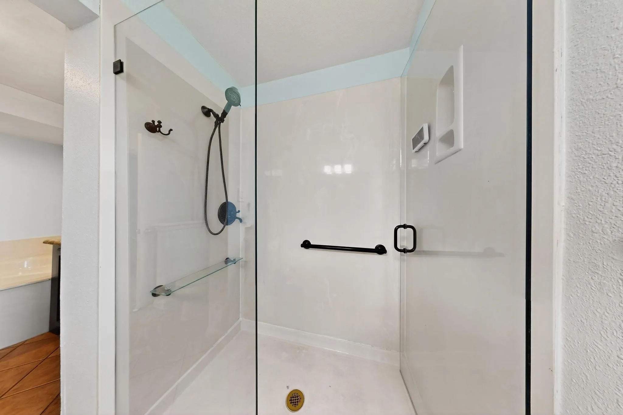 Bathroom with a shower stall and tile patterned flooring