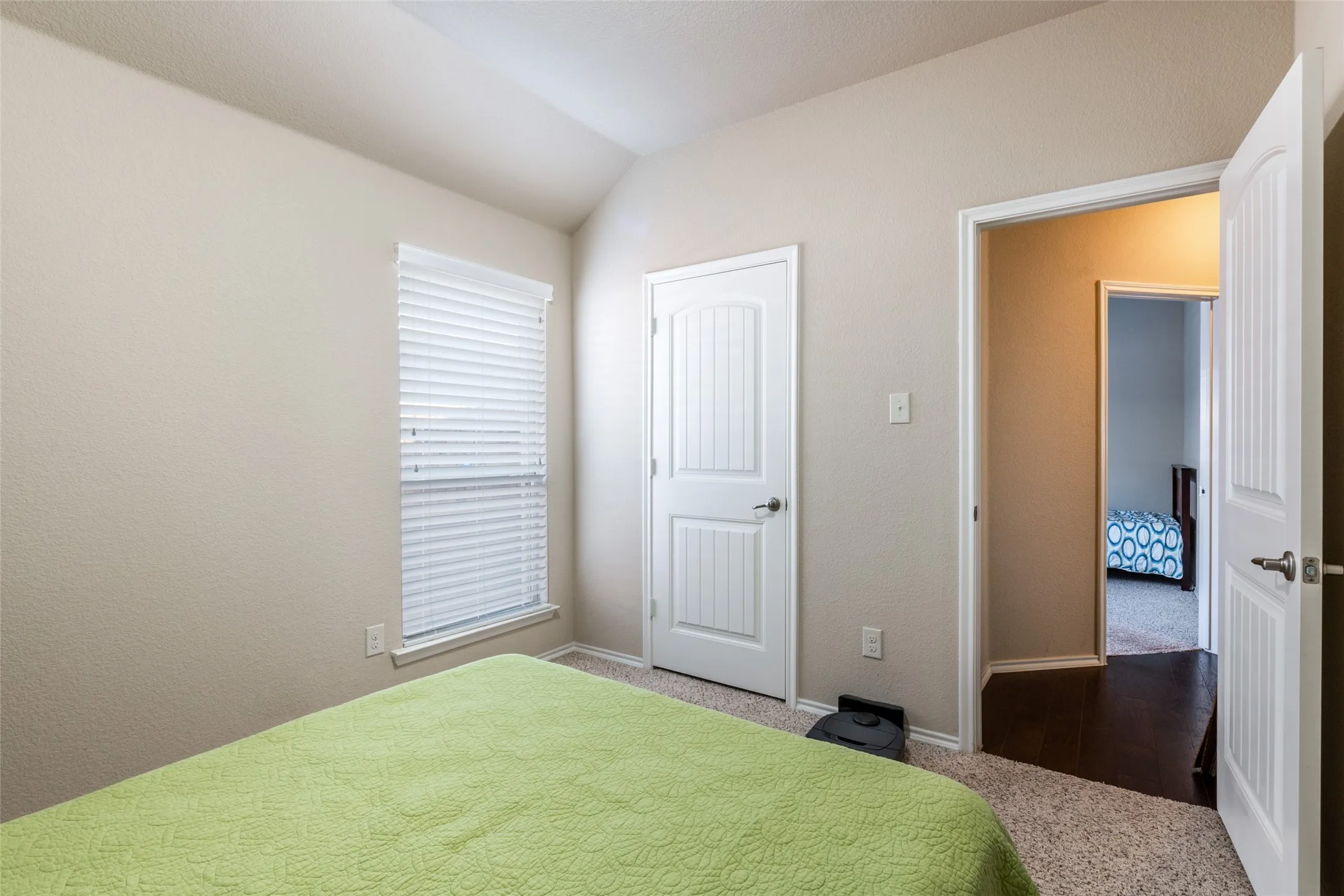 Bedroom featuring carpet floors and lofted ceiling