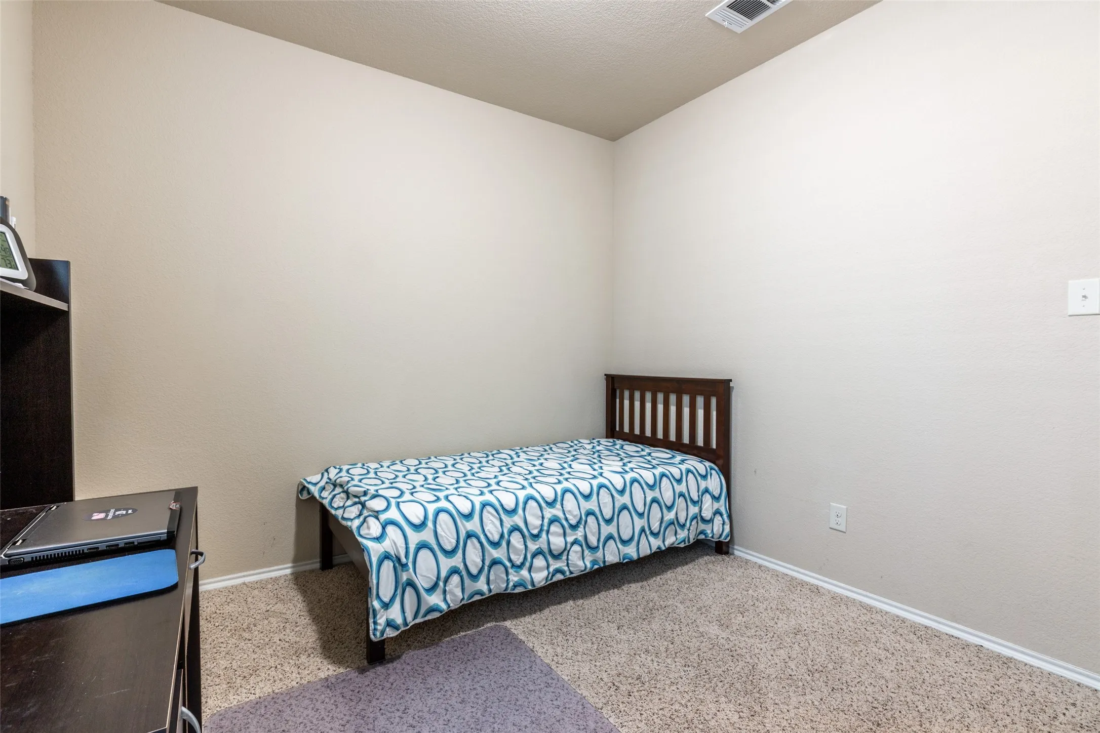 Carpeted bedroom with baseboards