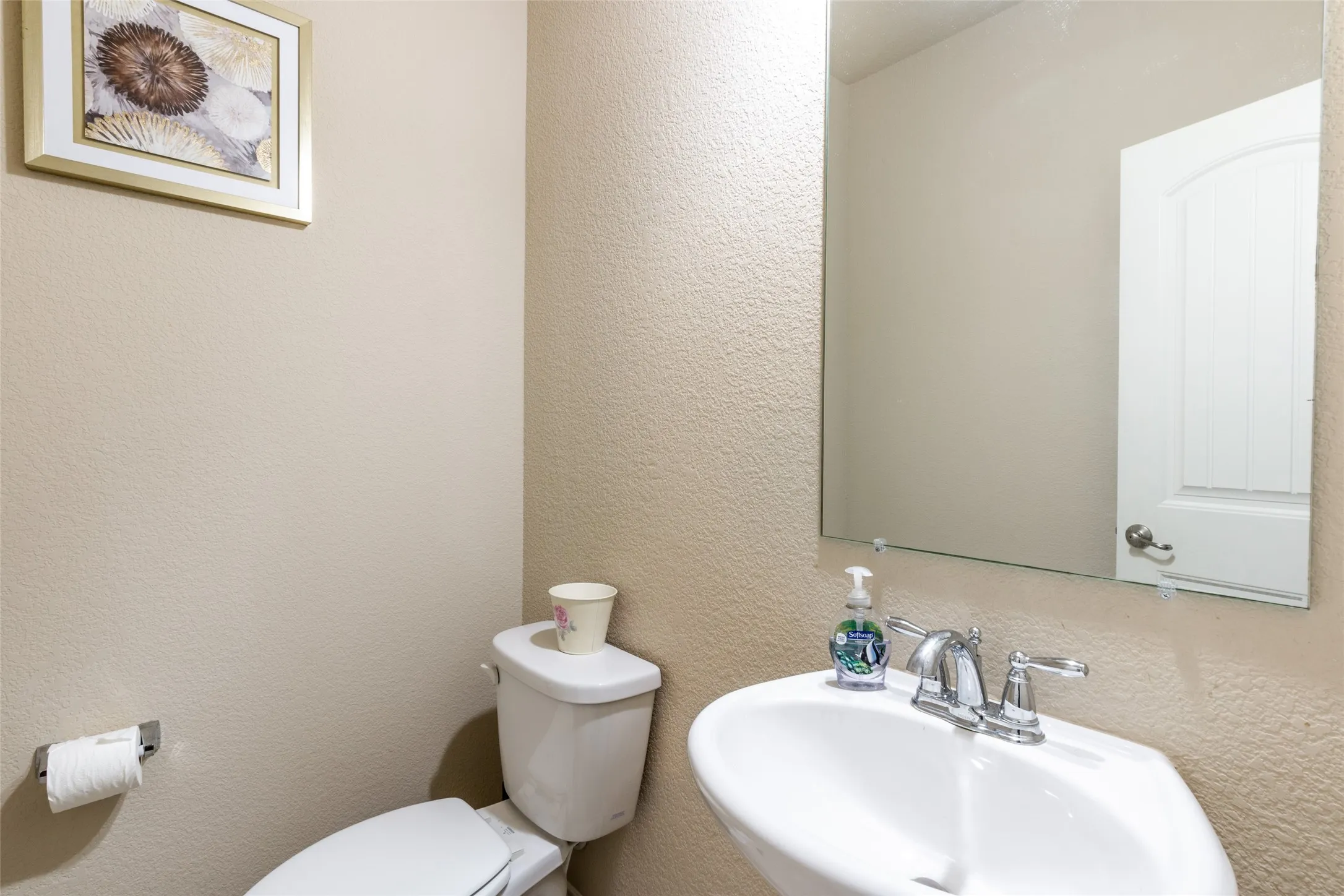 Half bath featuring a sink and toilet
