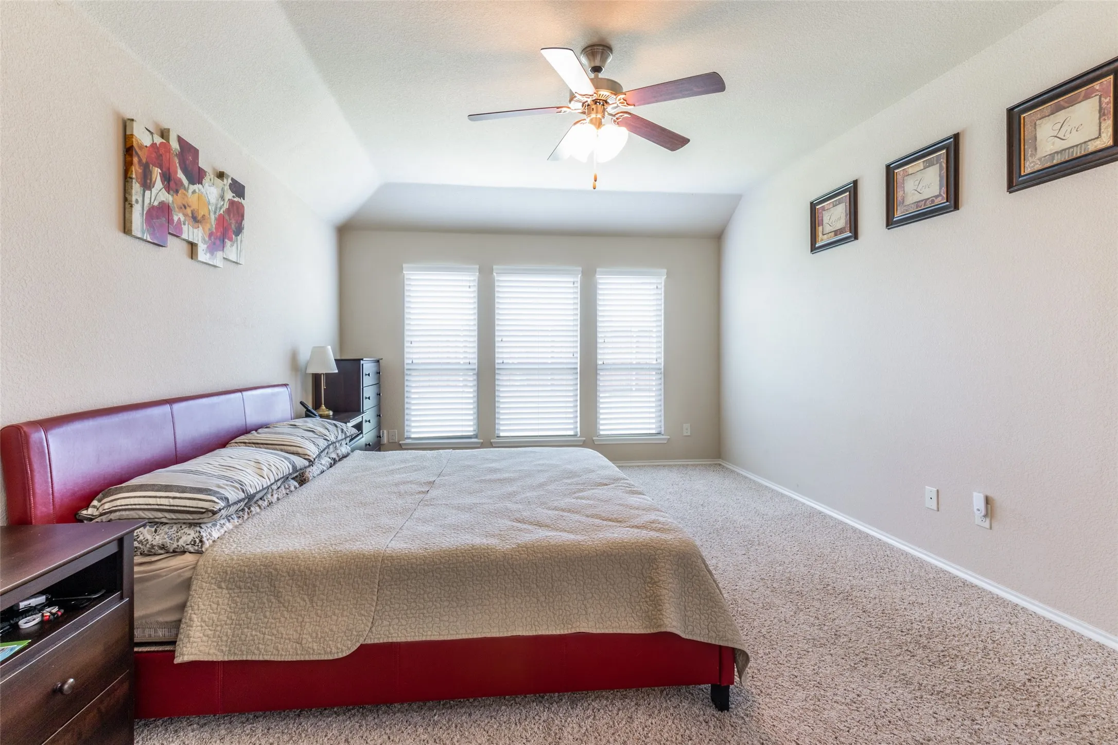 Bedroom with carpet floors, ceiling fan, and lofted ceiling