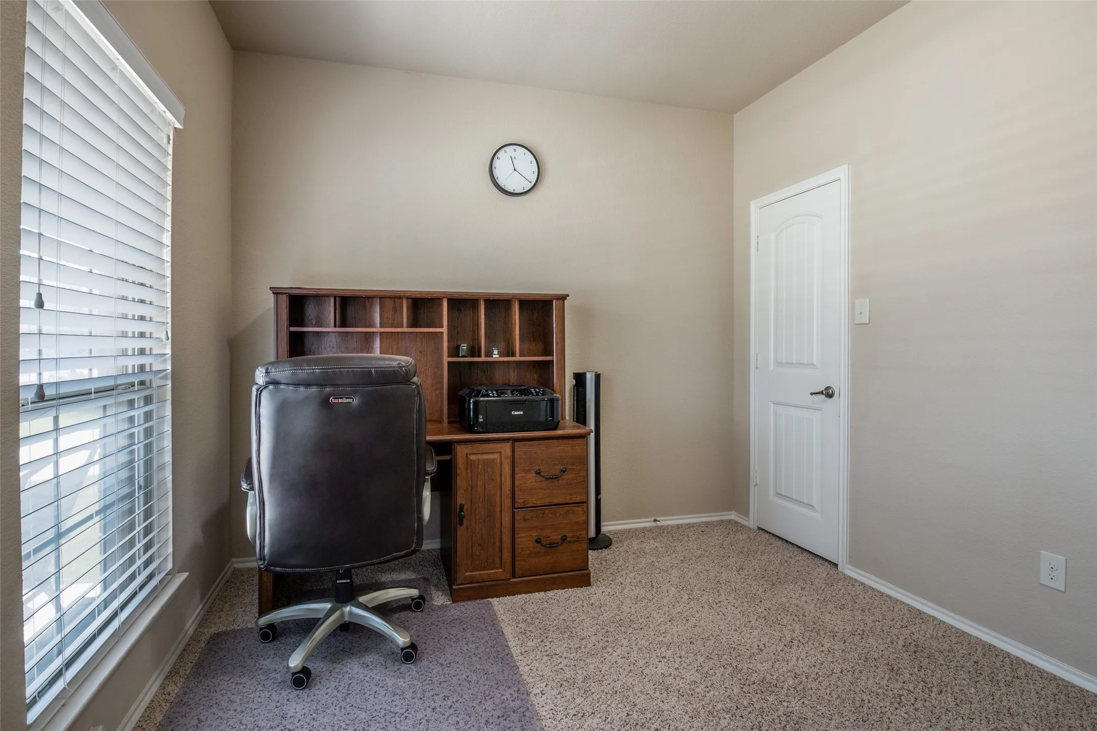 Carpeted home office with baseboards