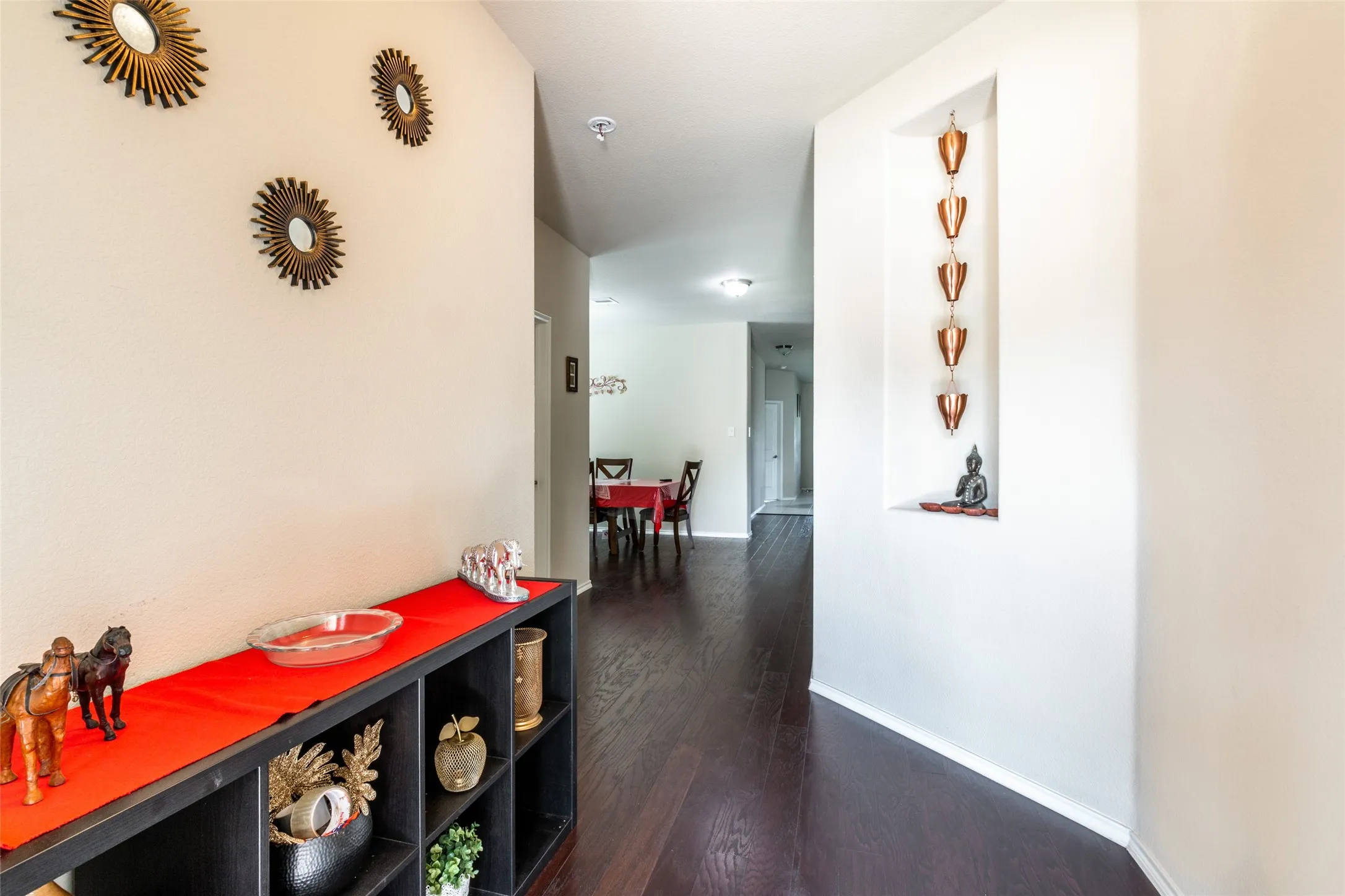 Corridor featuring dark wood-type flooring and baseboards