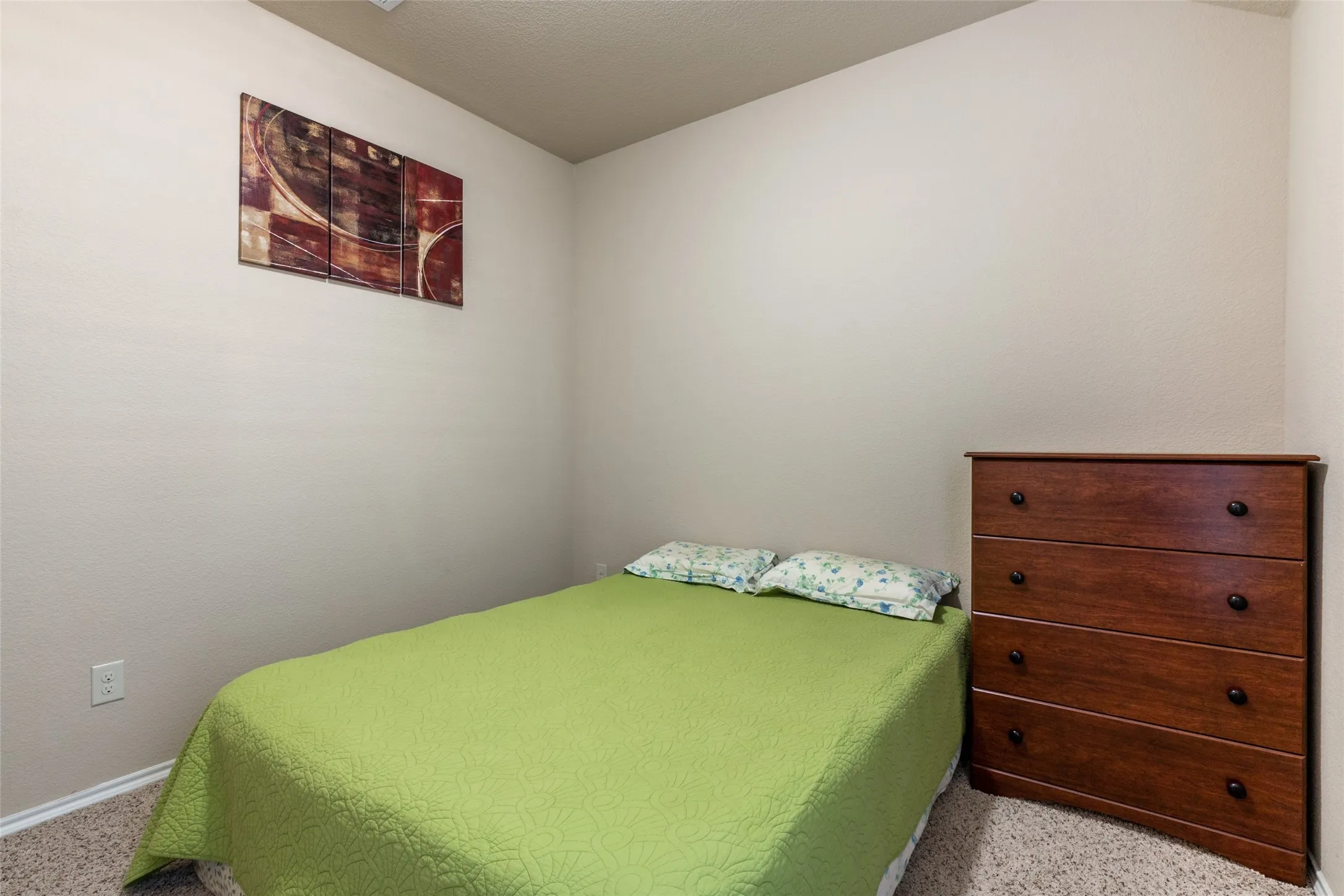 Carpeted bedroom with baseboards