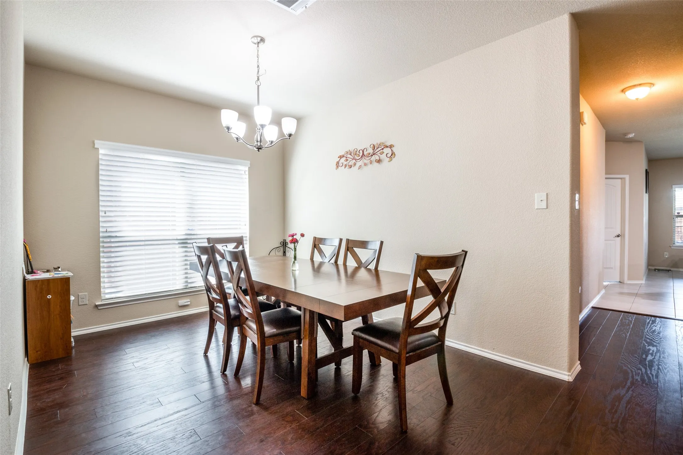 Dining room featuring hardwood / wood-style floors, a chandelier, and plenty of natural light