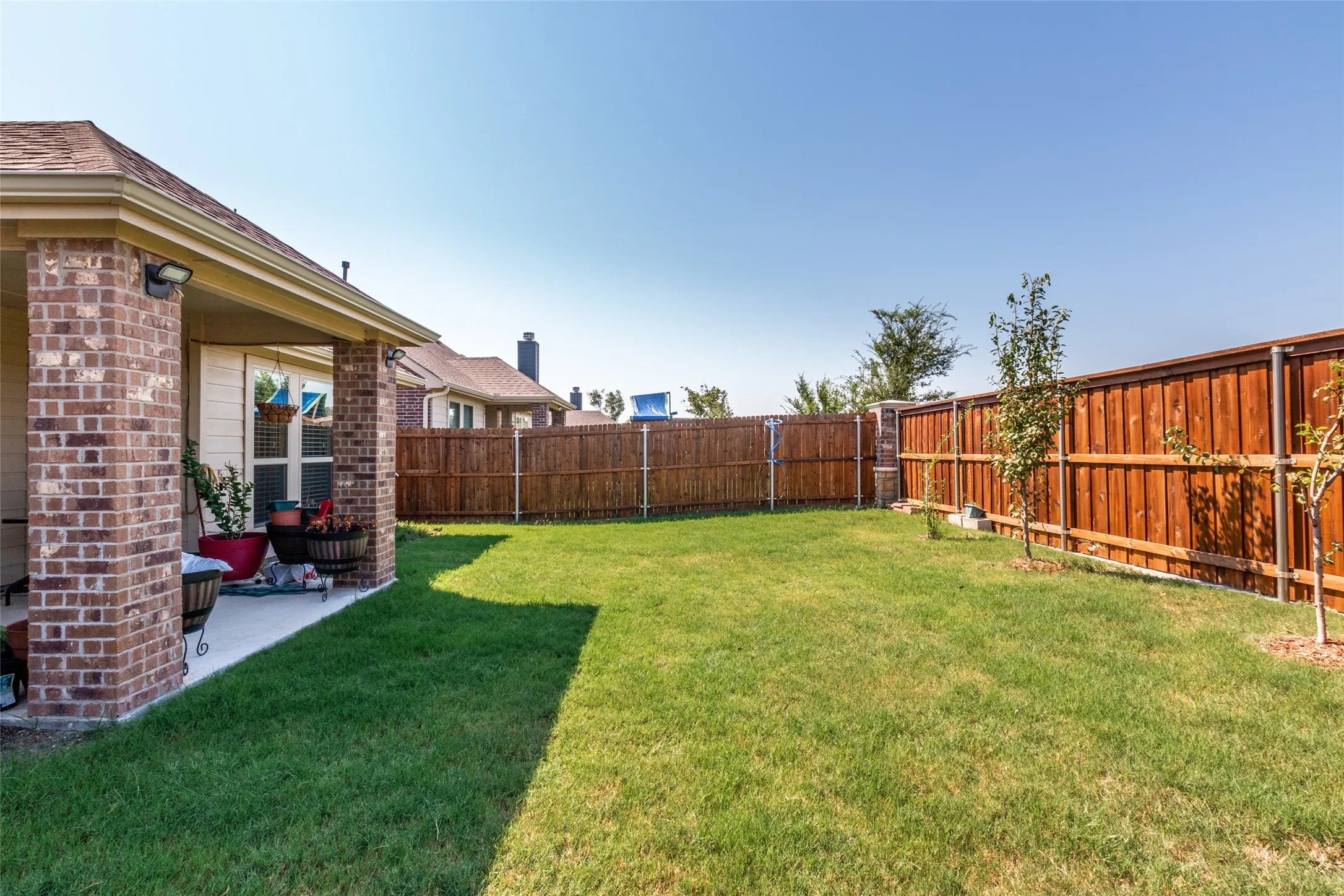 Fenced backyard with a patio