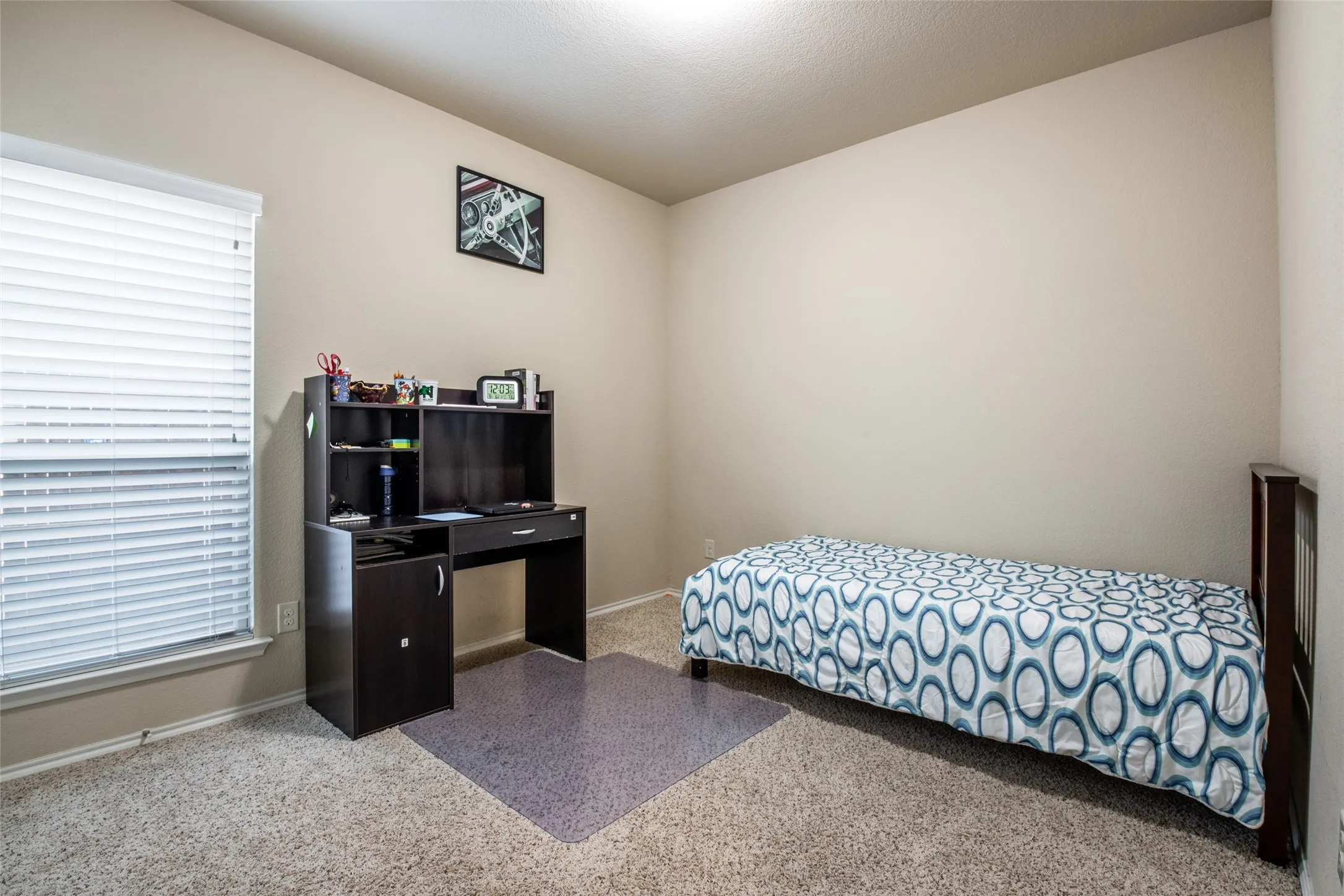 Carpeted bedroom featuring baseboards