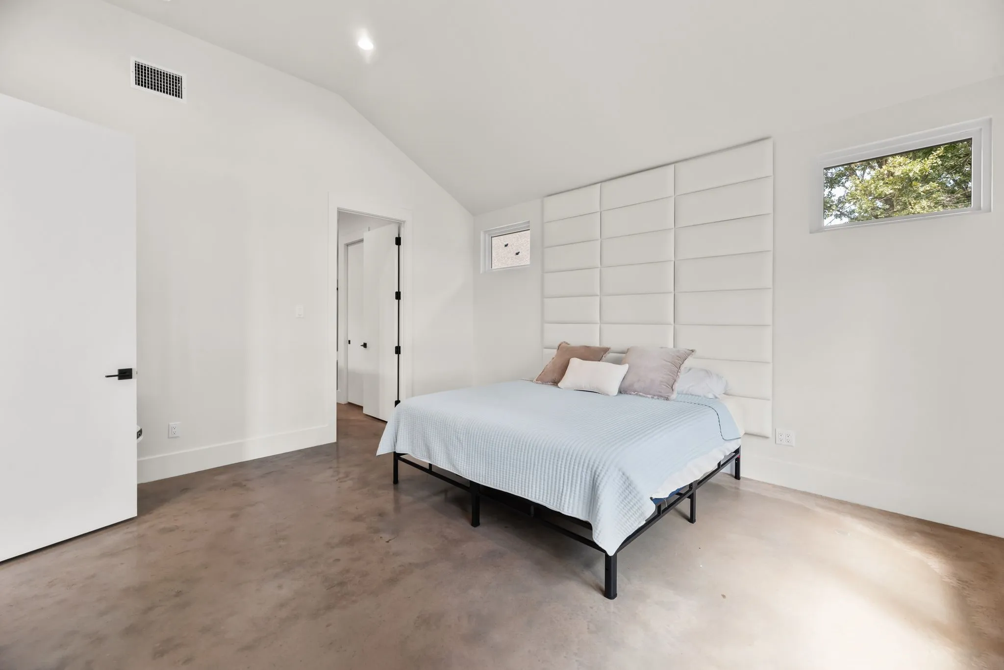 Spacious primary bedroom at 708 Clear Water Court offers a private retreat with modern finishes and convenient ensuite bath access.
