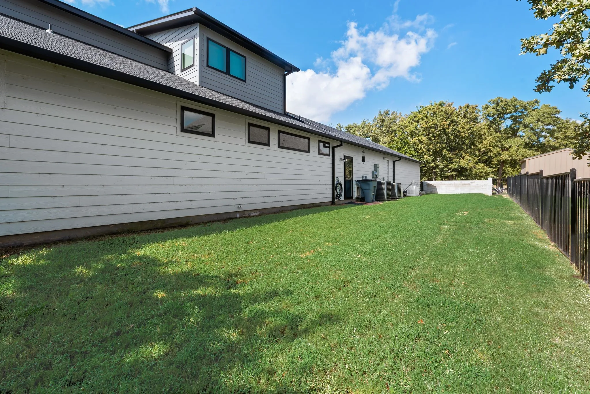 Fenced side yard provides additional usable outdoor space and privacy alongside this contemporary home in The Shores.