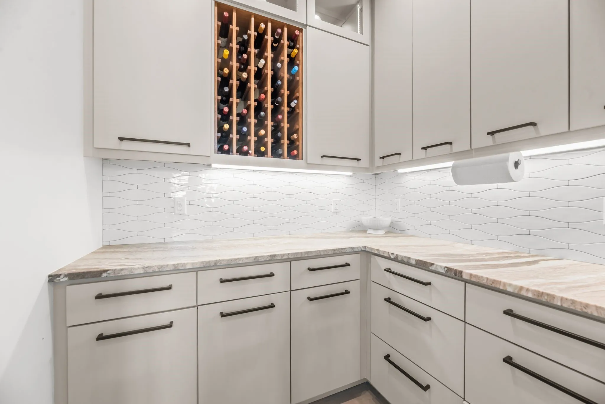 Butler's pantry provides additional cabinetry, counter space, and built-in wine storage for convenient entertaining and everyday organization.