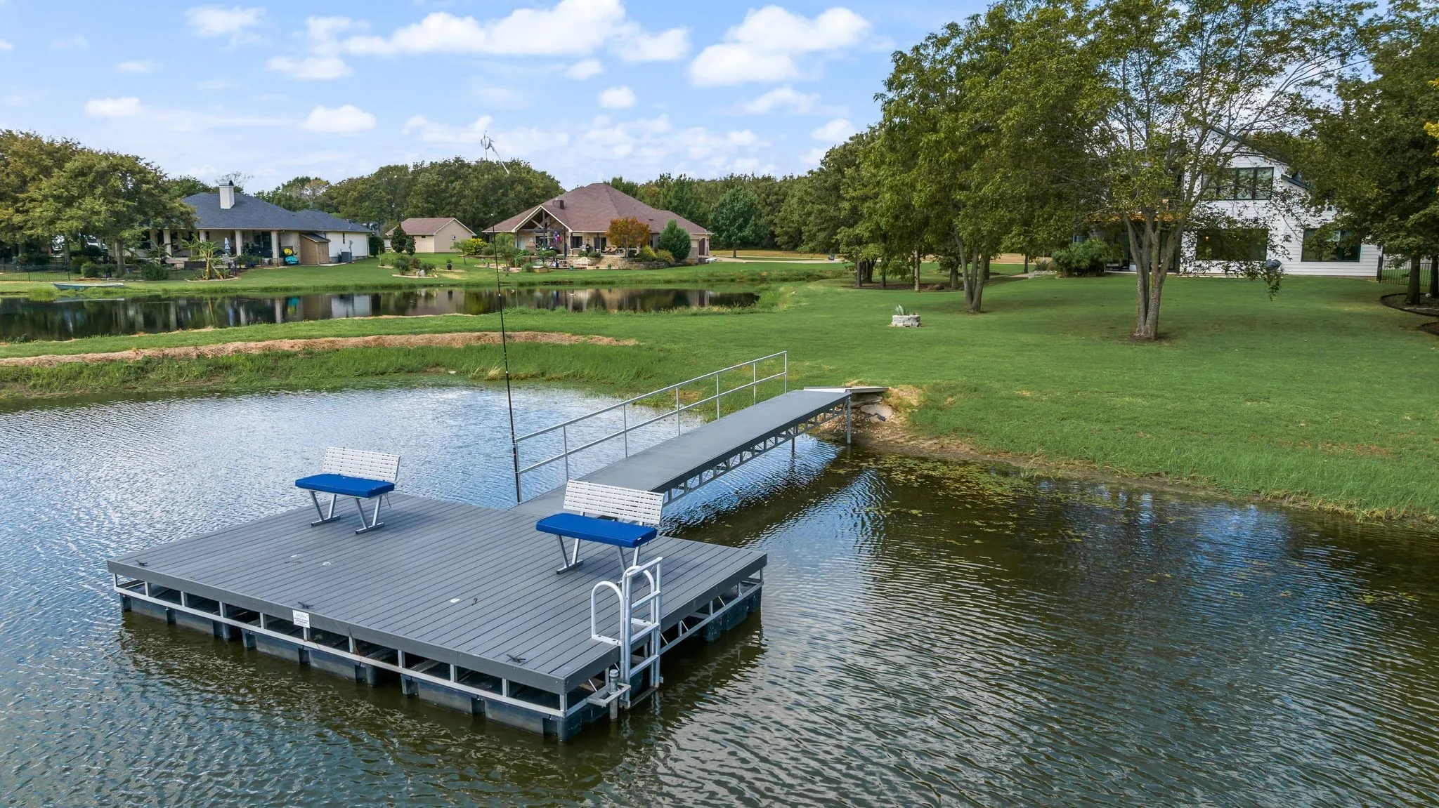 Elevated view of the private dock highlights the property's pond frontage and peaceful waterfront environment near Richland Chambers Lake.