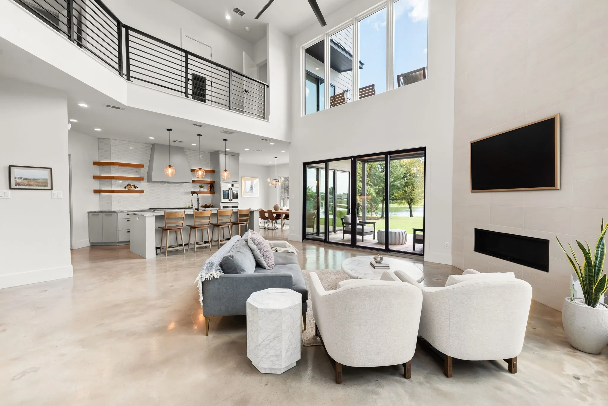 Open-concept living area at 708 Clear Water Court connects seamlessly with the kitchen while oversized windows bring the outdoor setting into view.