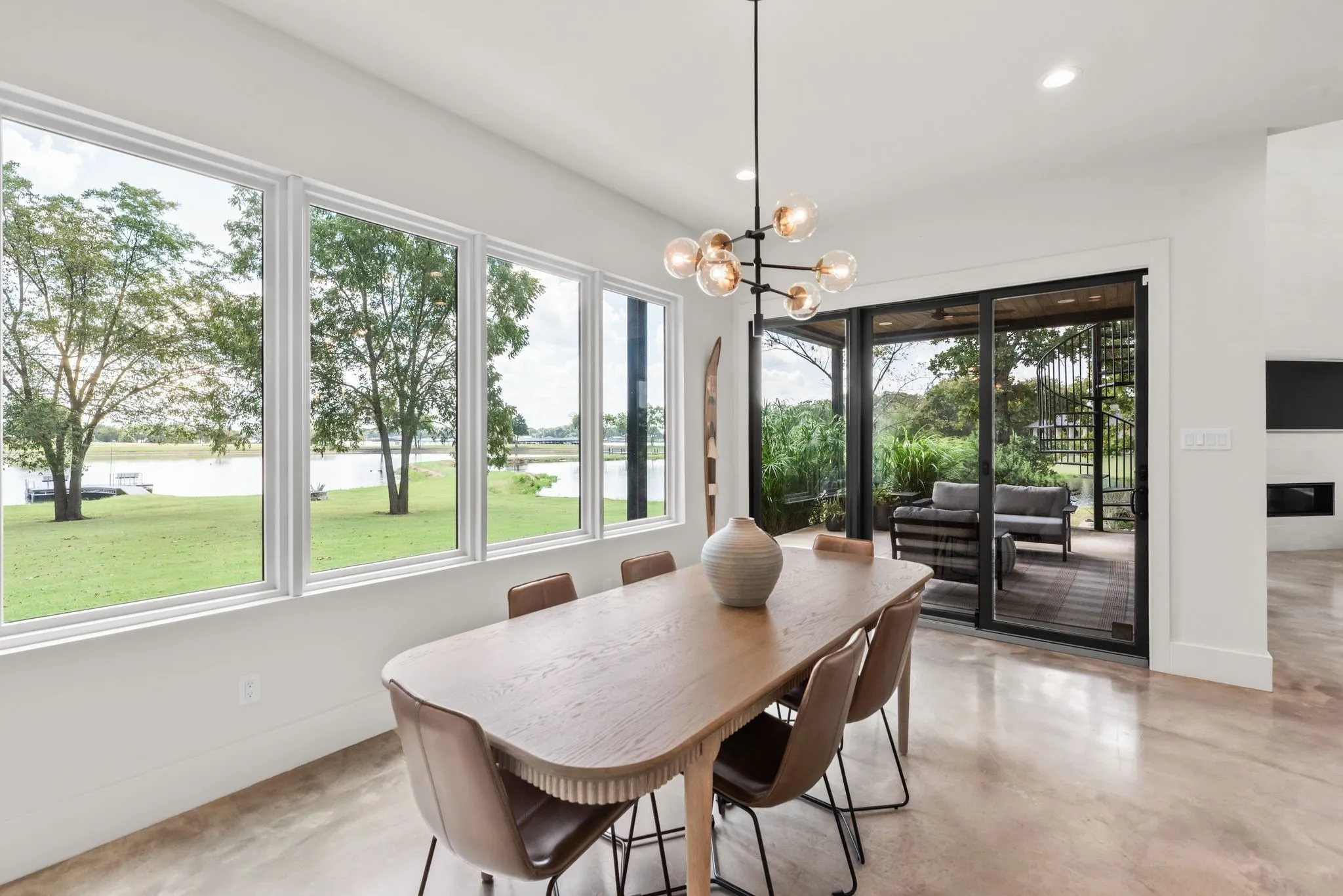 Dining area at 708 Clear Water Court is surrounded by large windows that capture backyard and water views while filling the space with natural light.