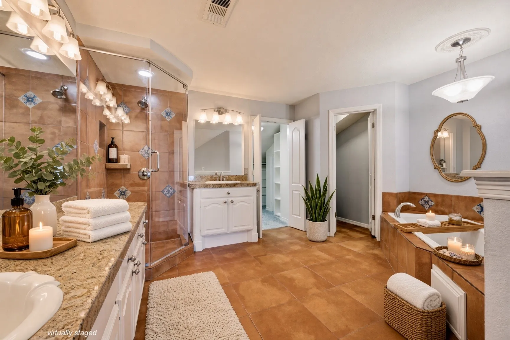 Primary Bathroom with dual vanities, jetted tub, separate shower, and walk in closet.