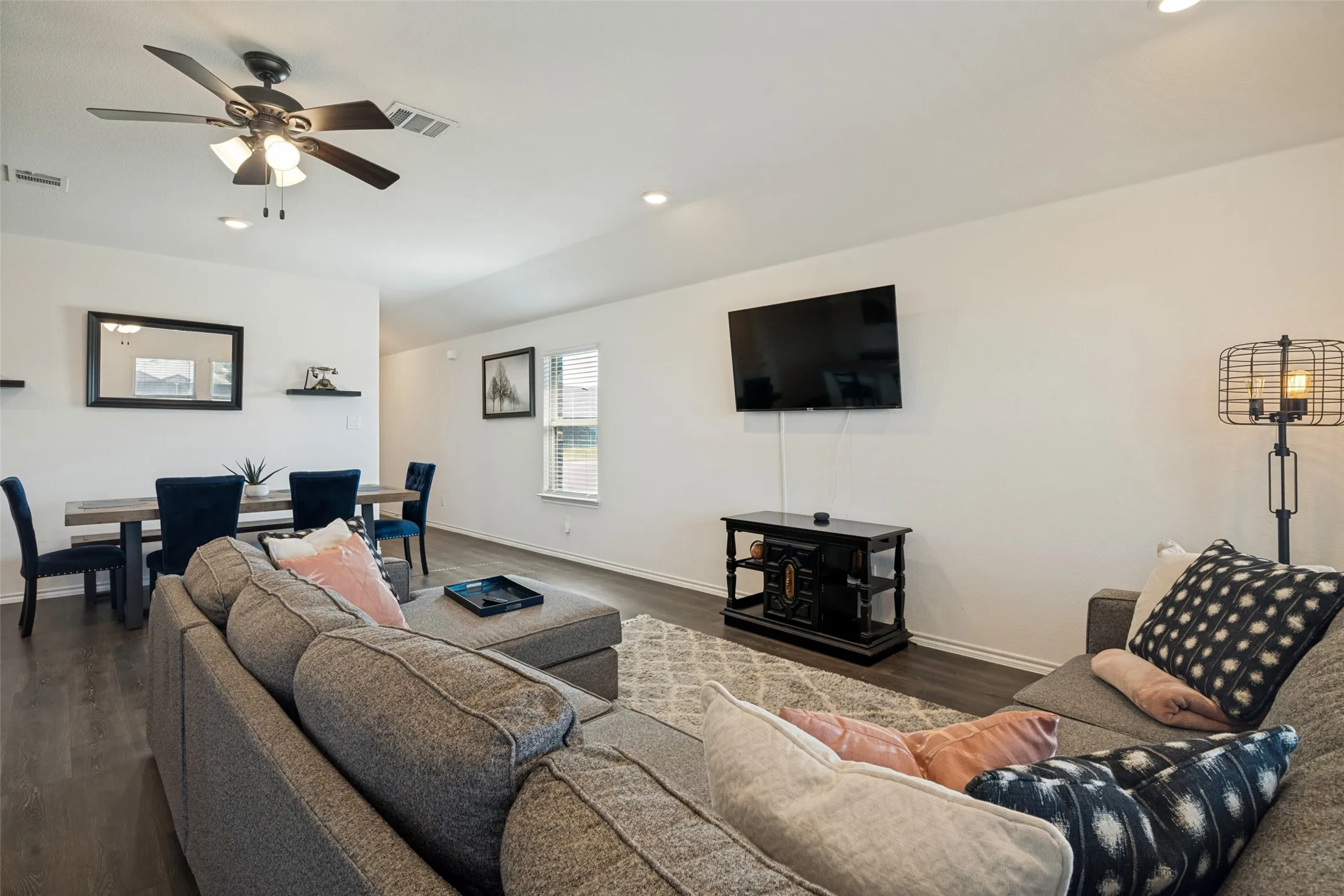 Open-concept living space featuring wood-finish flooring, recessed lighting, and a ceiling fan