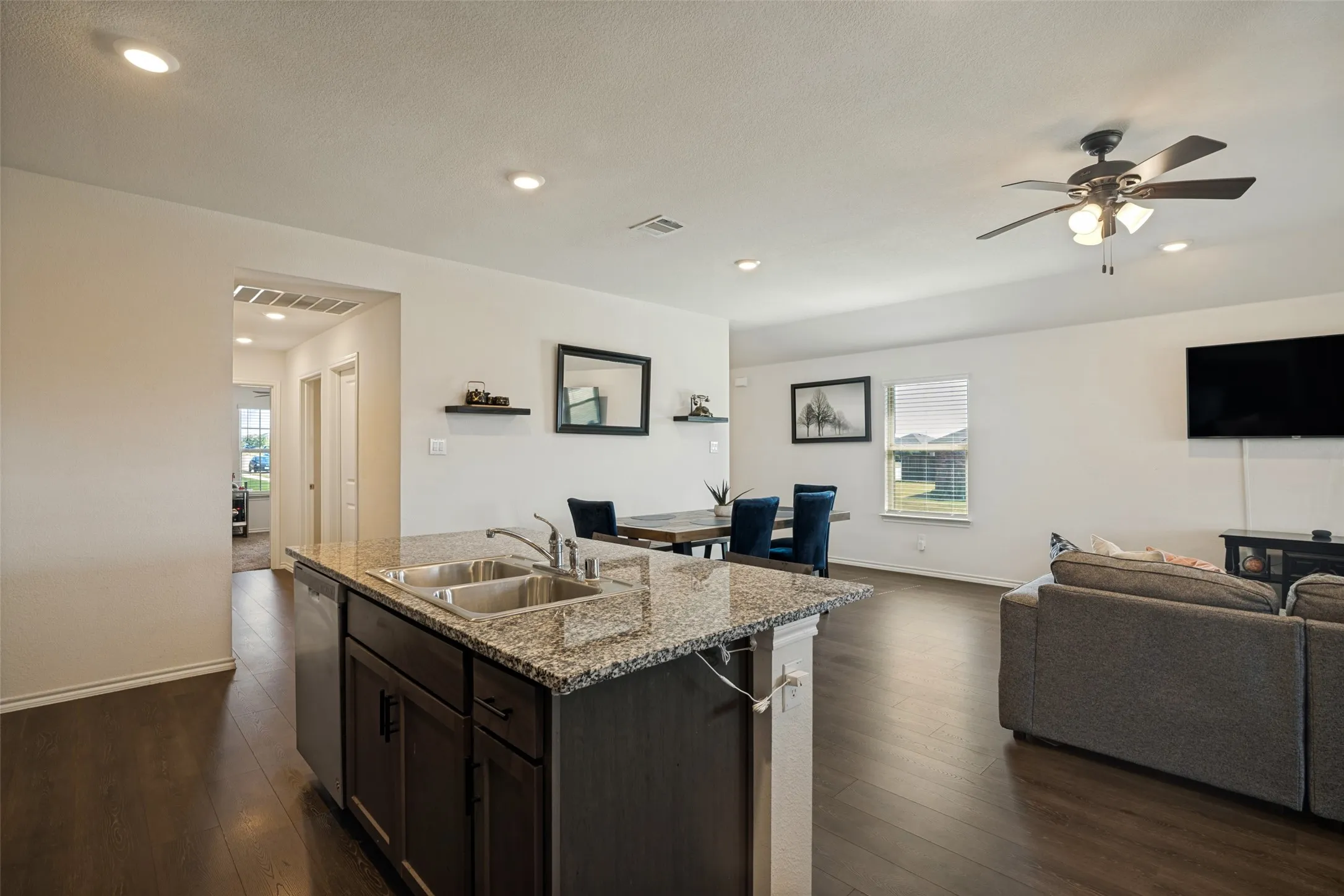 Kitchen island with dual sinks and granite-finish countertop