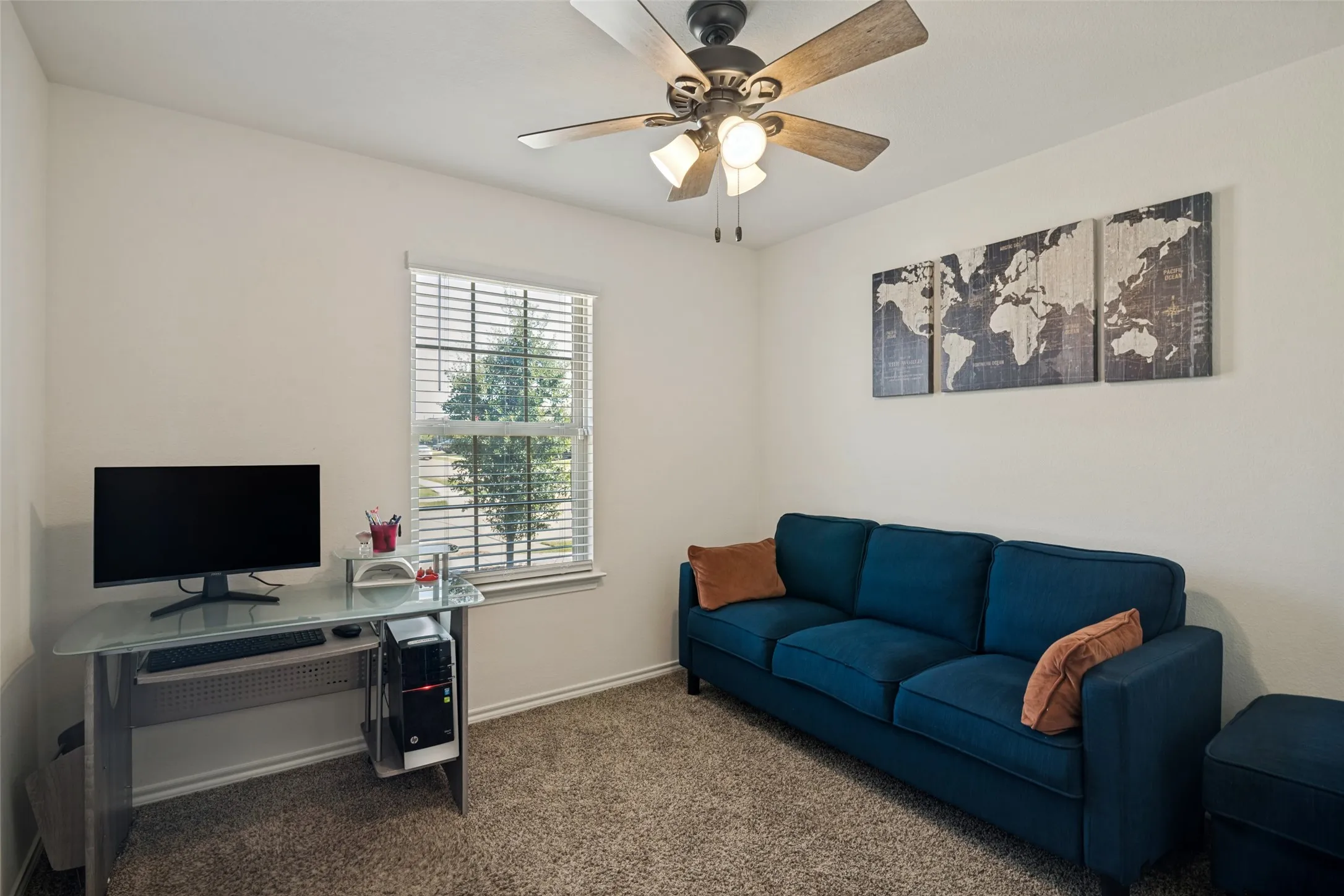 Ceiling fan with light fixture, single window with horizontal blinds, neutral wall paint, and textured carpet