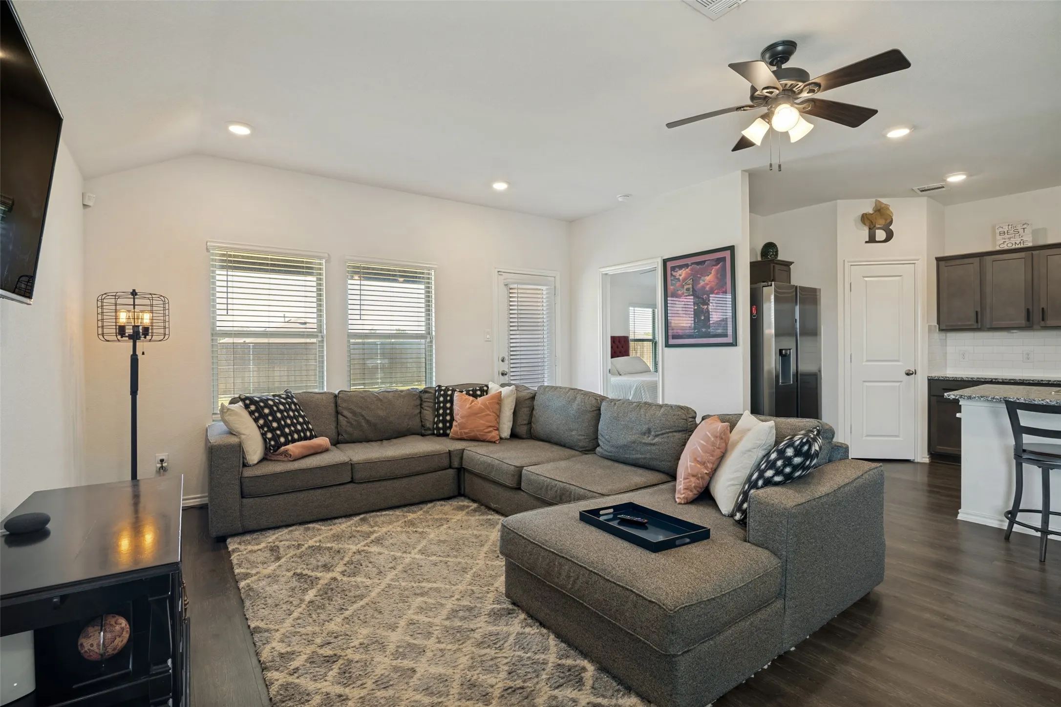 Spacious living area featuring high vaulted ceilings, recessed lighting, and wood-finish flooring