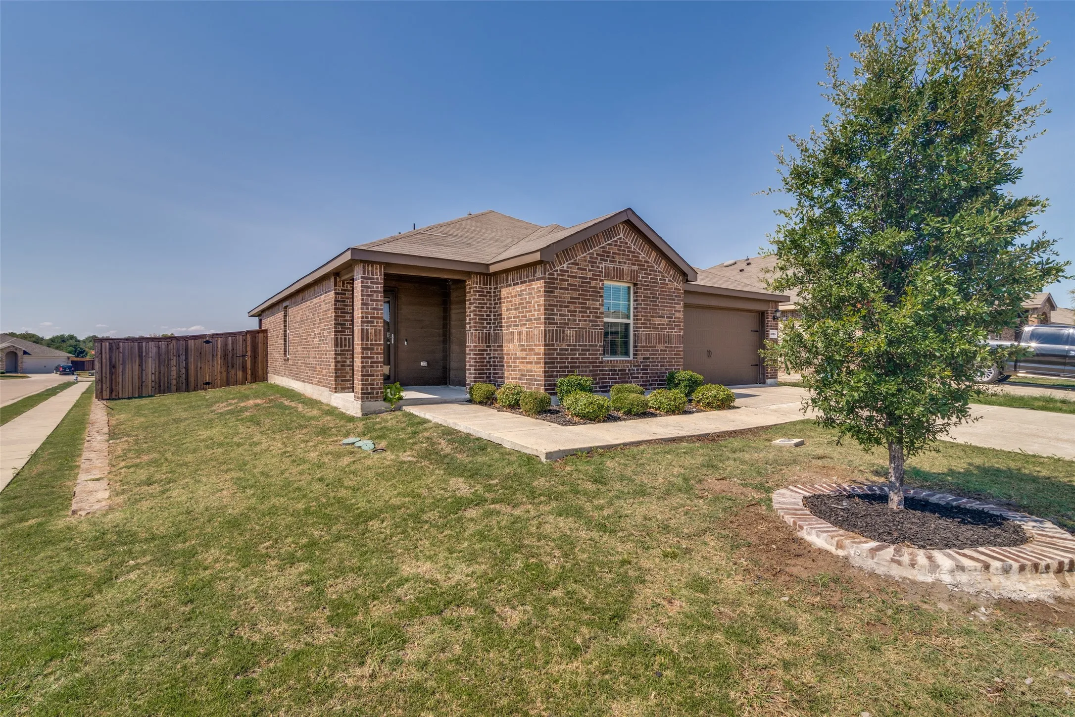 Brick exterior with a covered entry and an attached garage