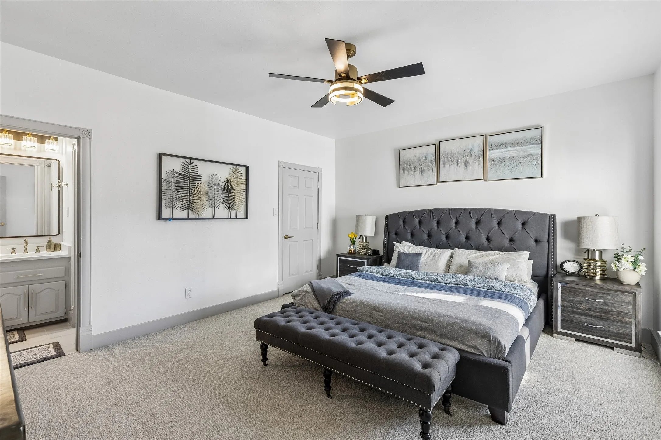 Plush carpet flooring, a contemporary ceiling fan, and a neutral wall color define this space