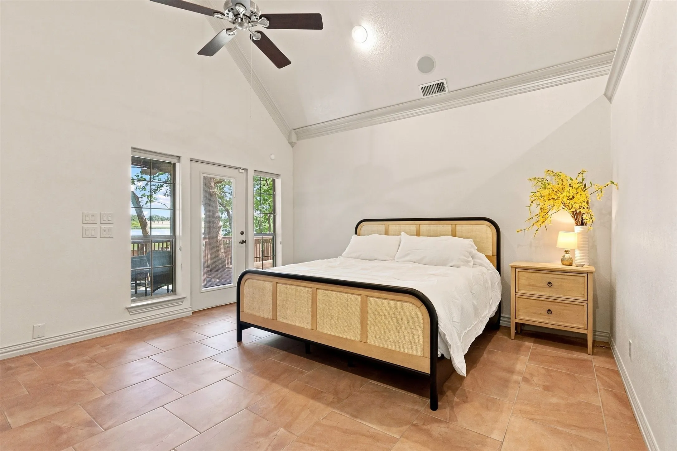 Vaulted ceiling with crown molding, ceiling fan, and recessed lighting