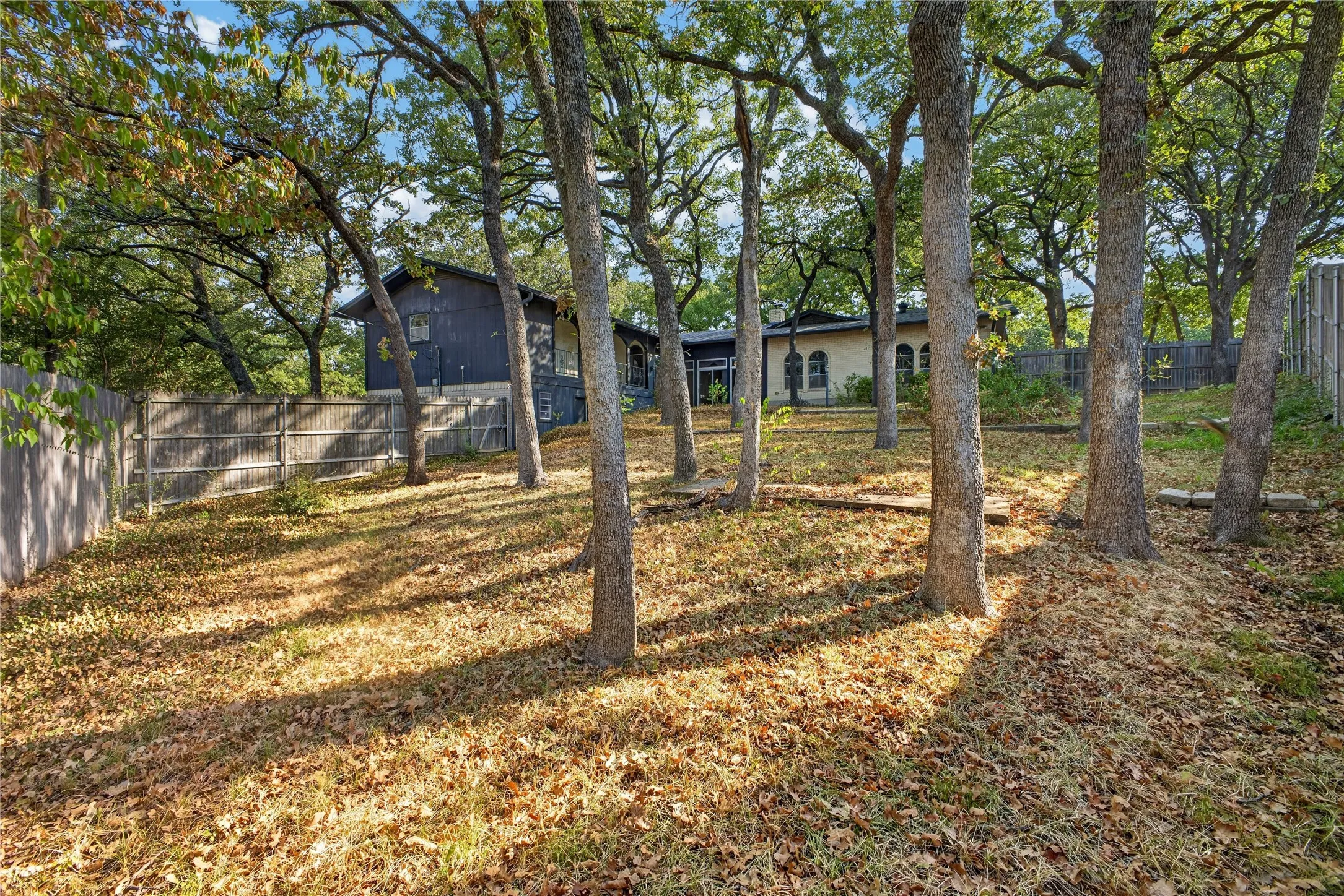 Terraced backyard shaded by mature trees on the .37-acre lot.