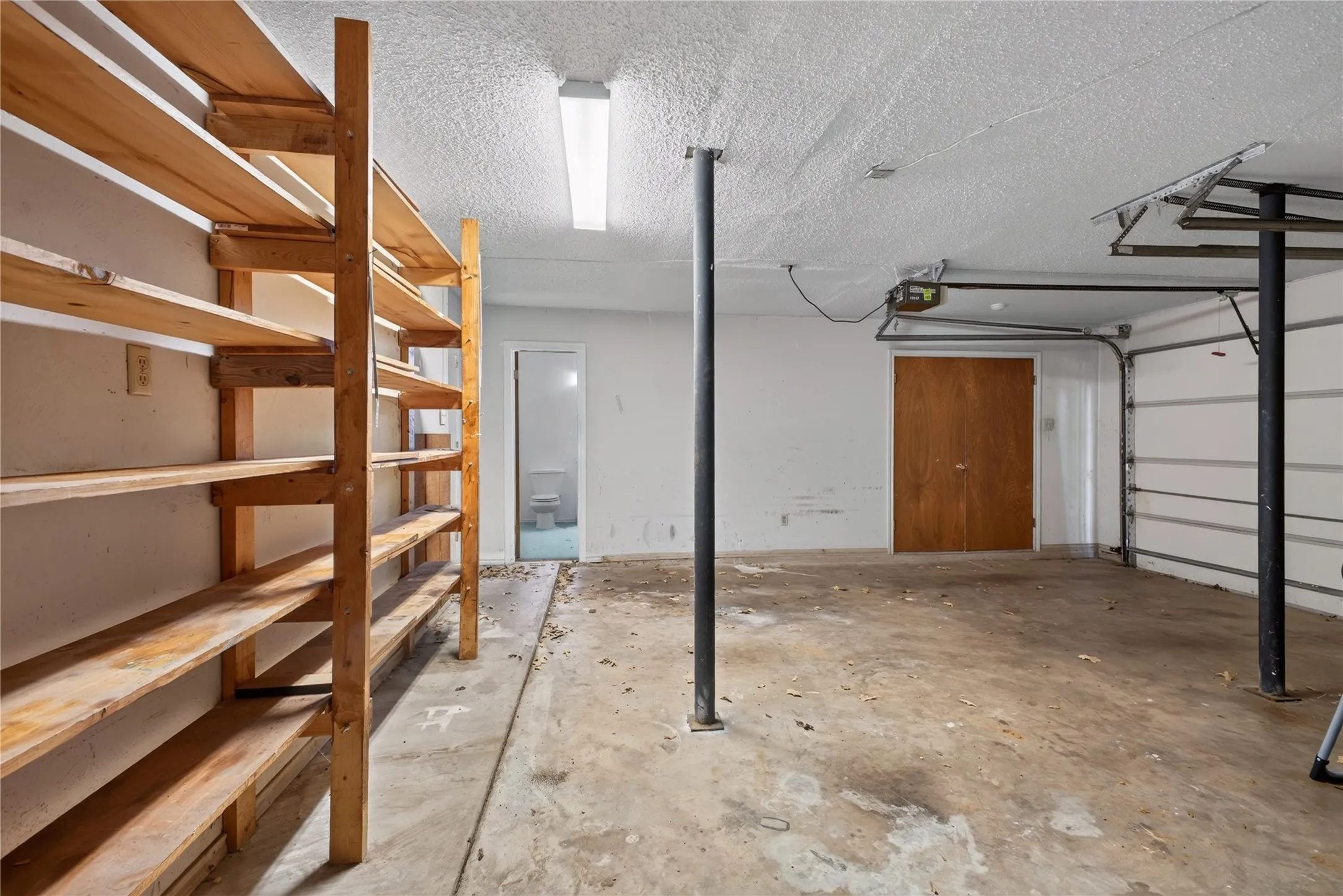 Two-car garage with additional storage room; garage is located below the main living level.