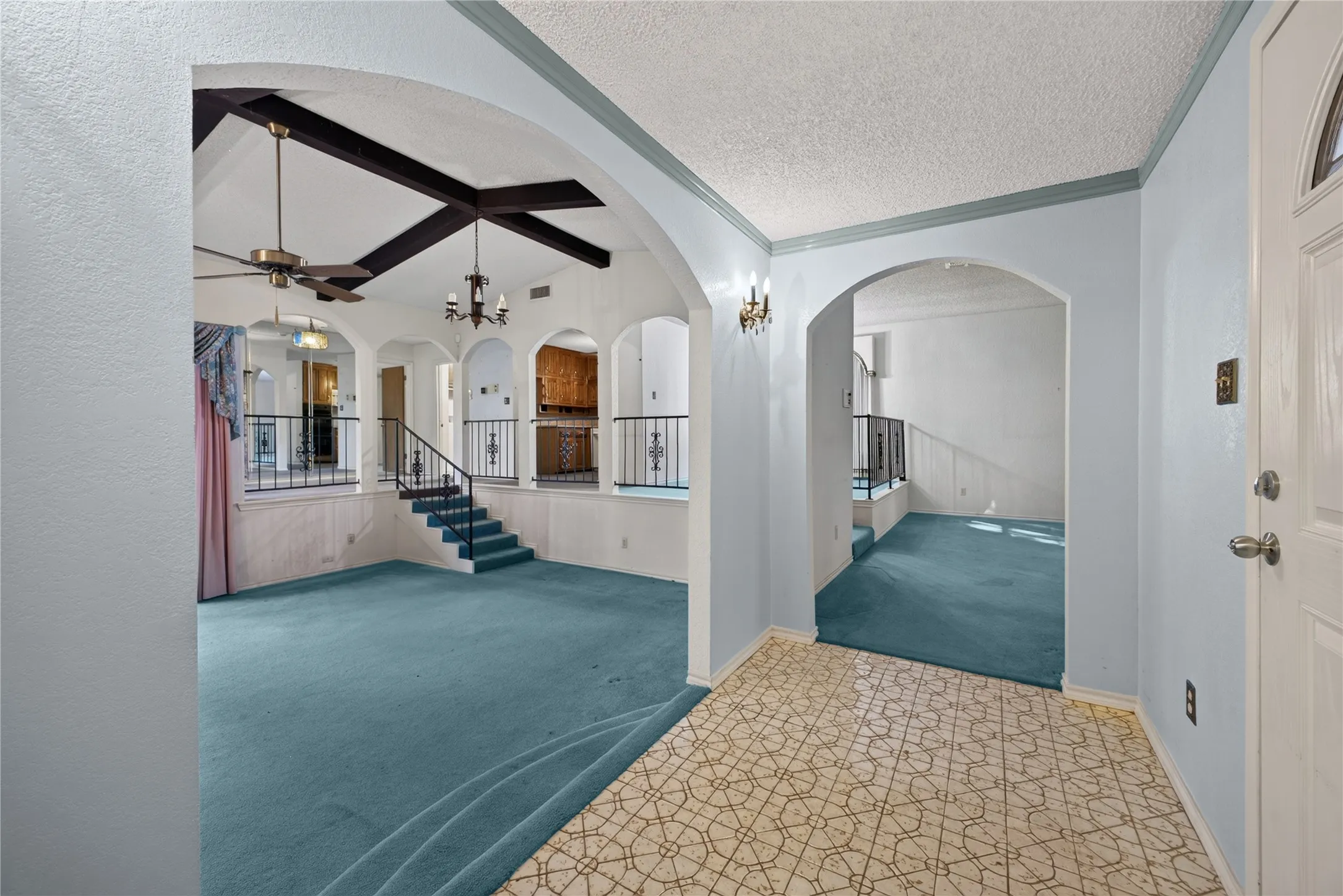 Entry opens to multiple living and dining spaces arranged around the sunken family room.