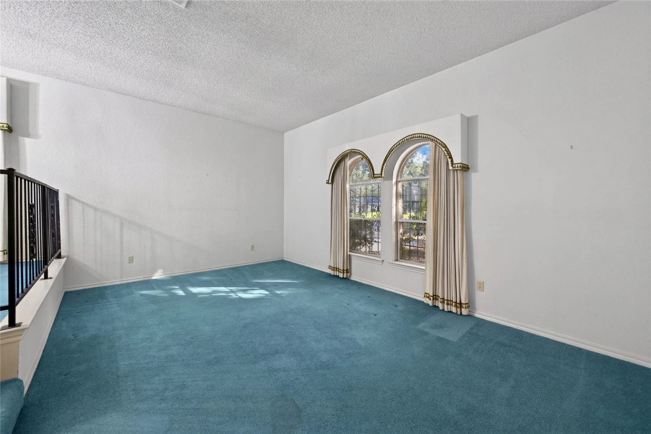 Additional living space with distinctive arched window.