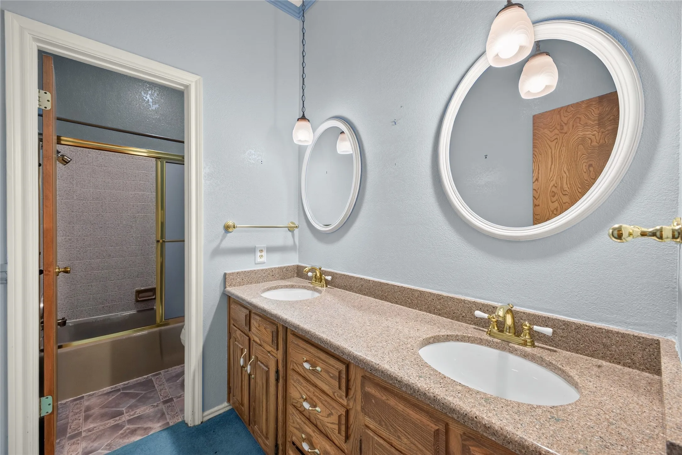 Second full bath with double vanity and original cabinetry.