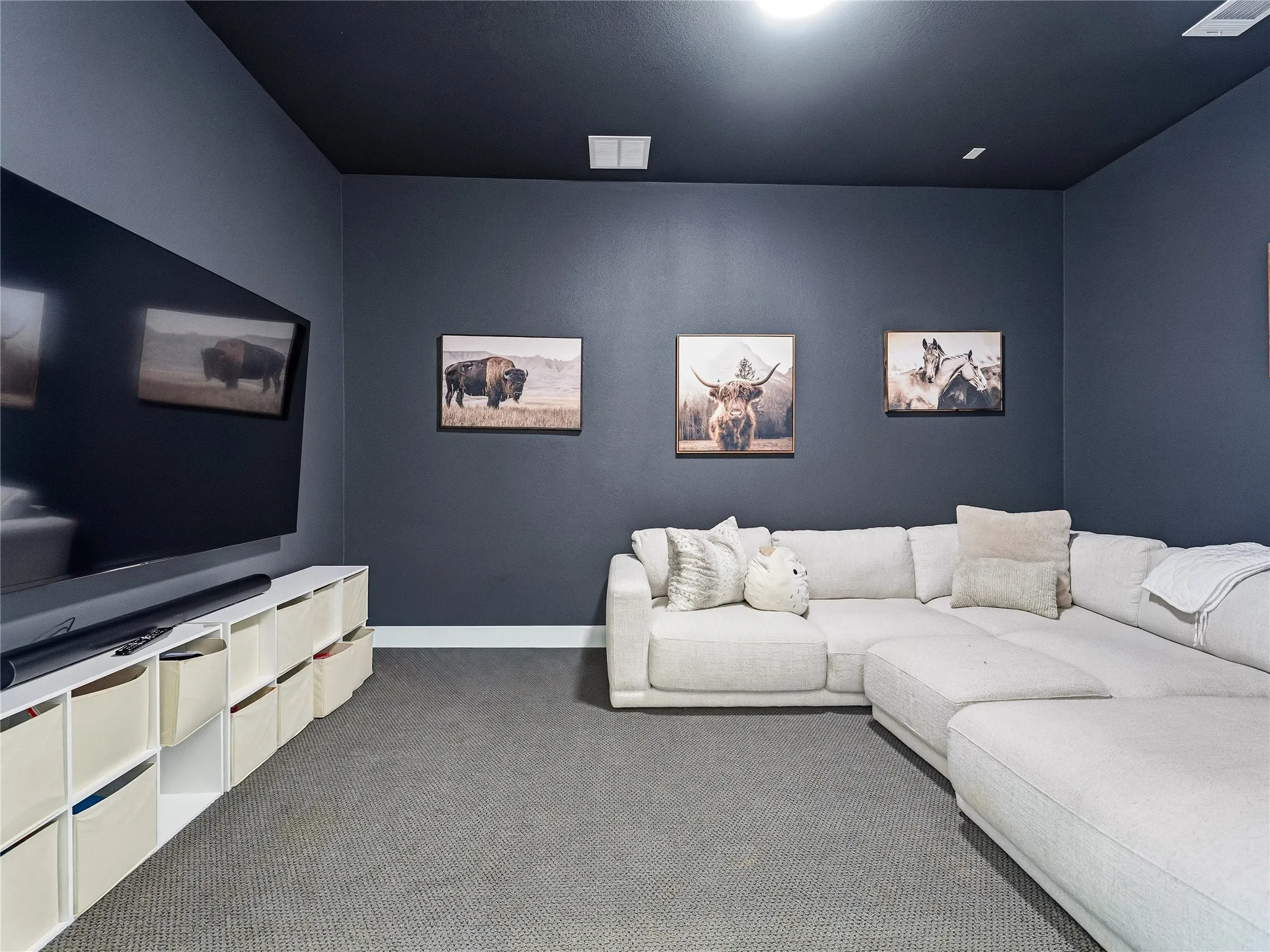Recessed lighting illuminates the dark-painted ceiling and walls