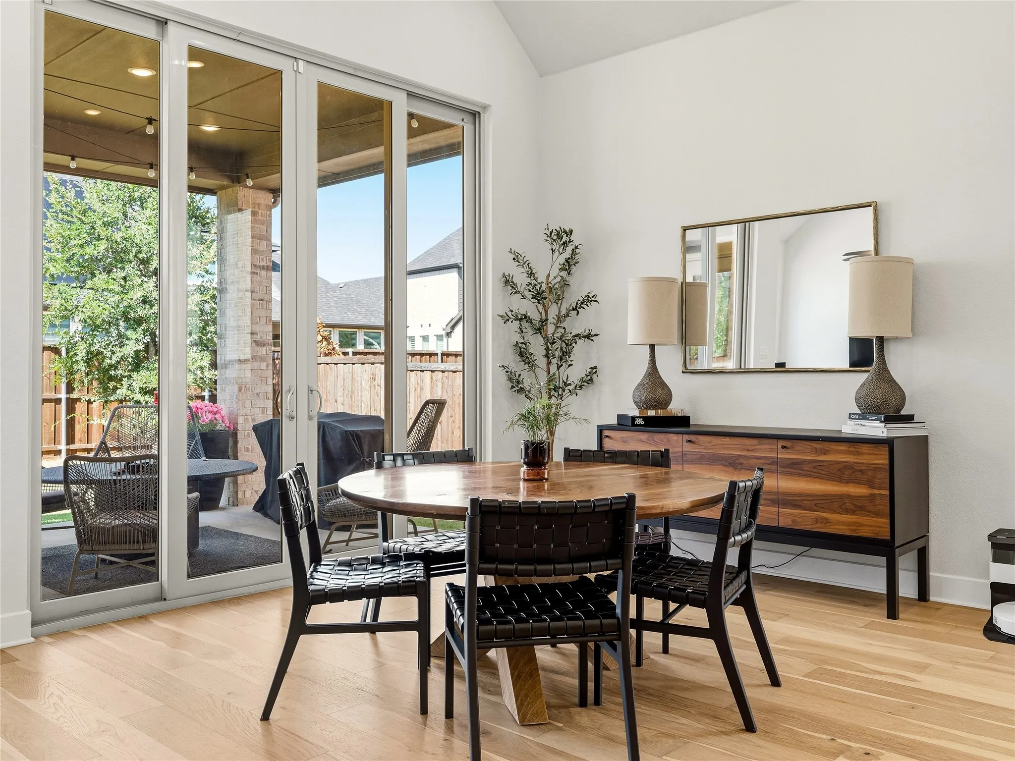 Light wood-finish flooring with white walls and a vaulted ceiling