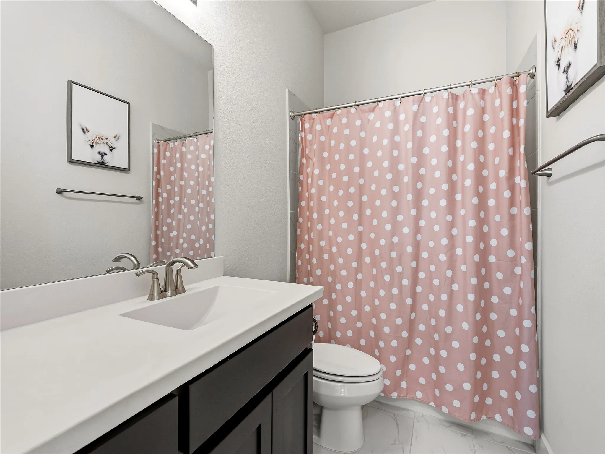 Bathroom featuring a vanity with dark wood-finish cabinetry, white countertop, and brushed nickel faucet
