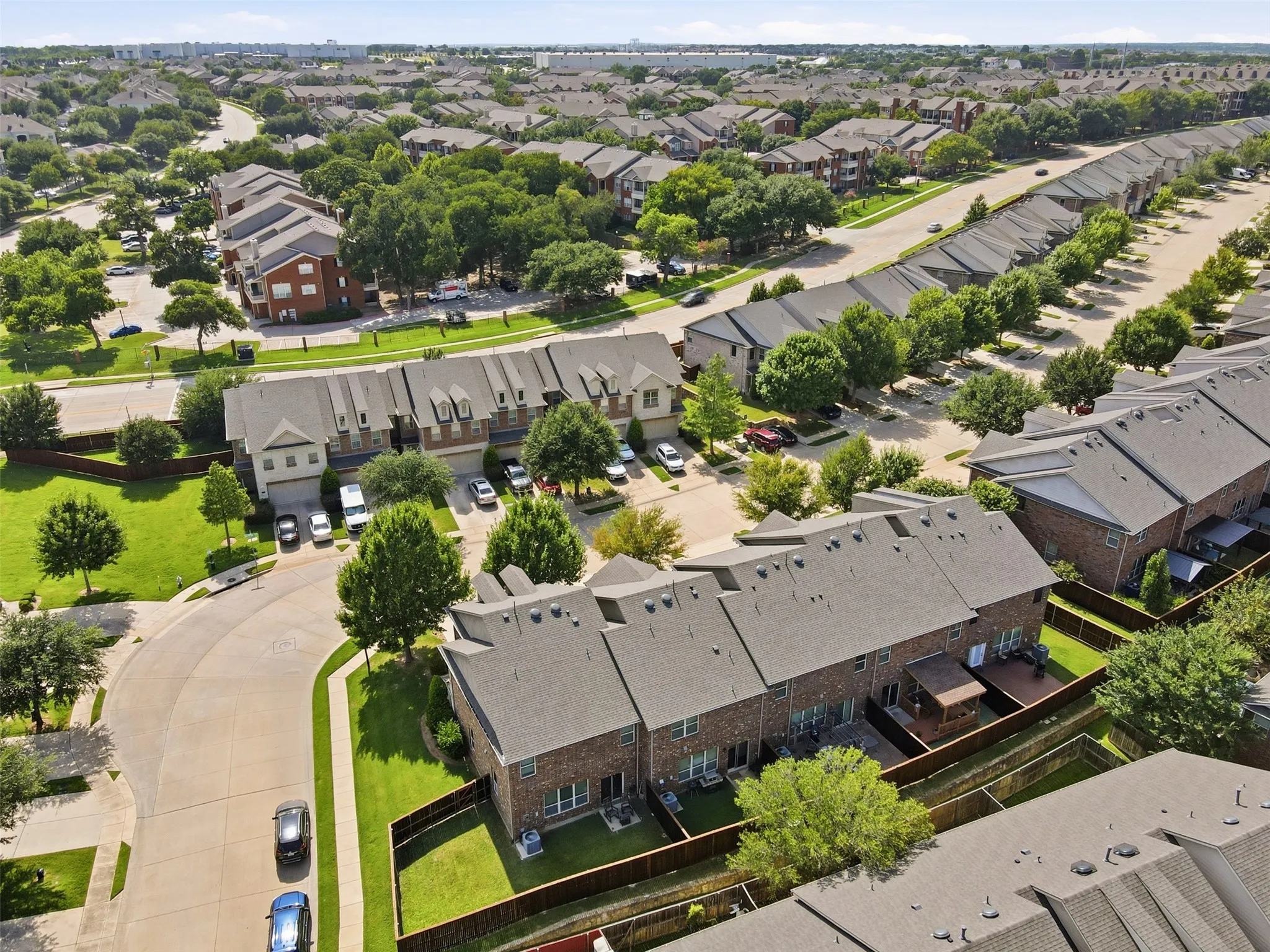 Townhome community with mature trees and paved roadways