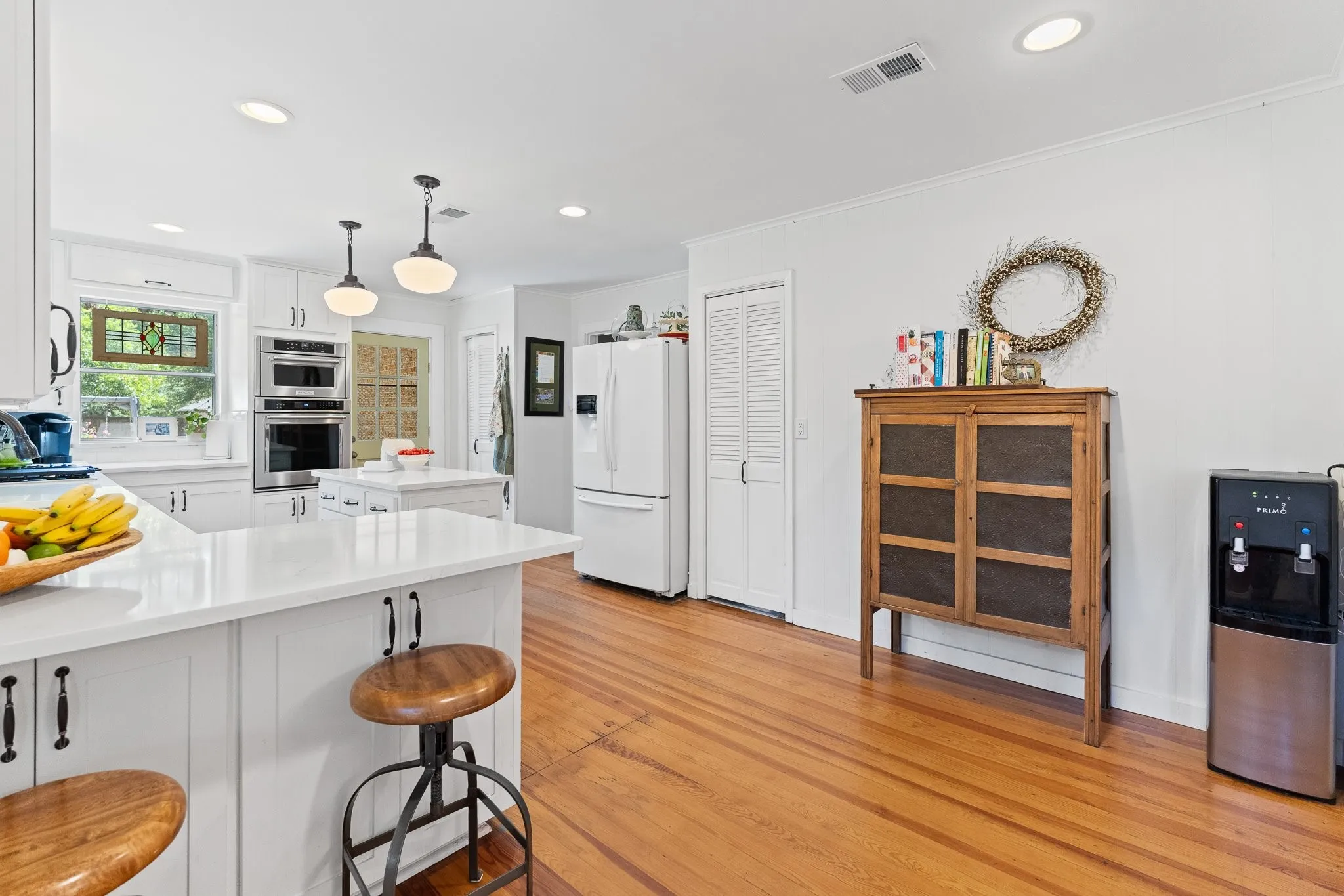 Tons of light and counter space AND cabinets in this all white kitchen!