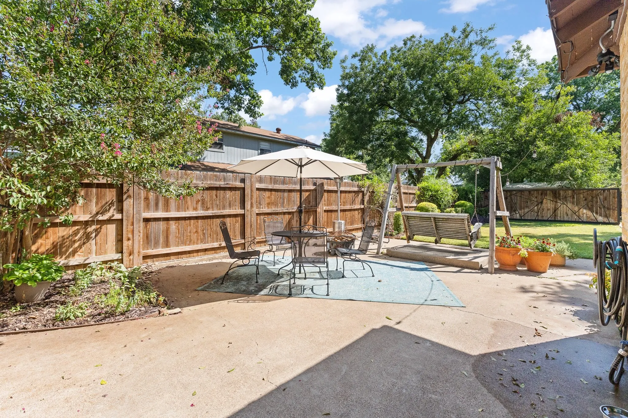 Swing and stand are excluded, but this is a wonderful back patio!