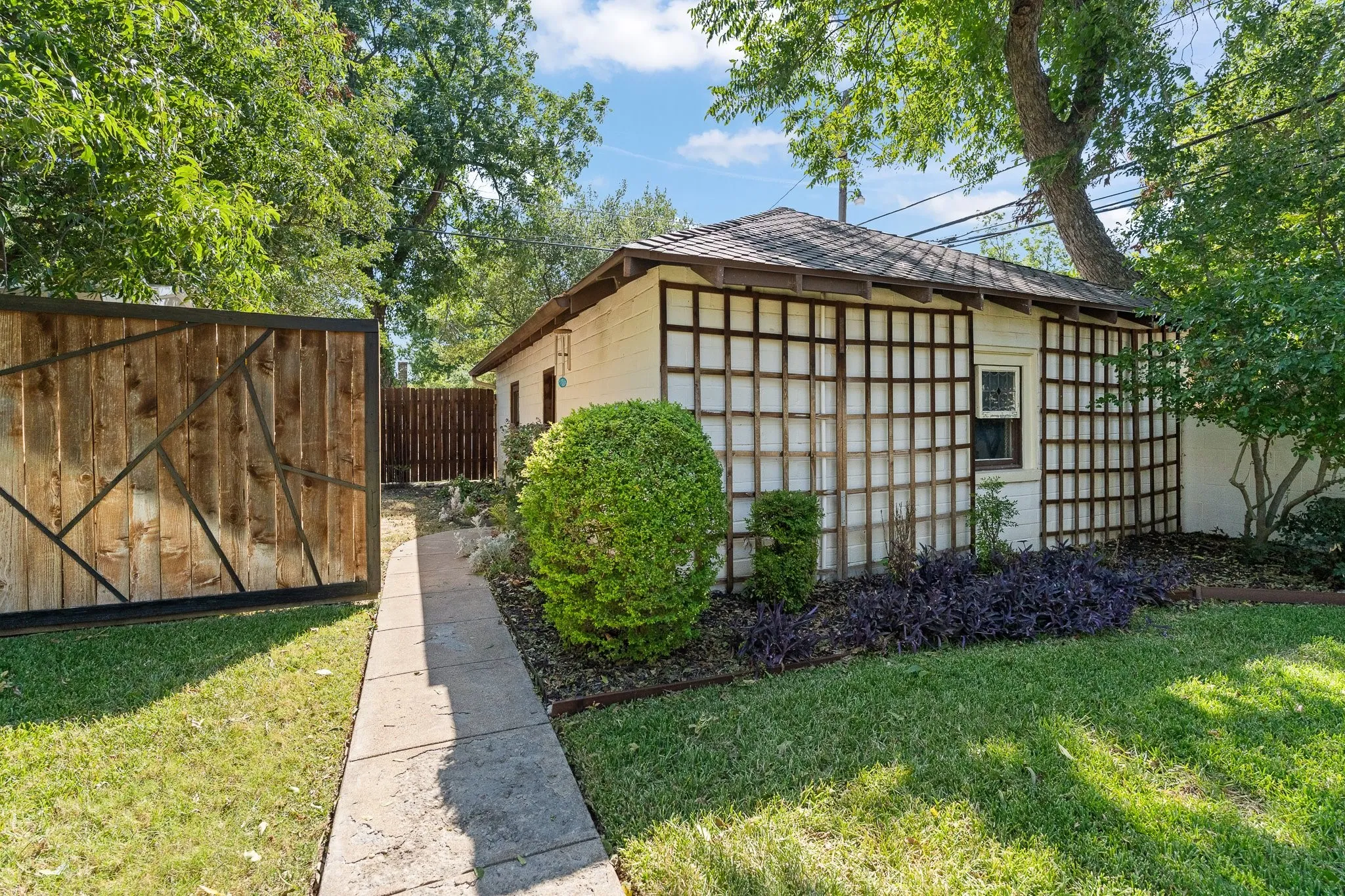 This is the walkway to the detached garage. Behind the fence on the left is a shed, but sellers built the decorative fence to hide the shed.