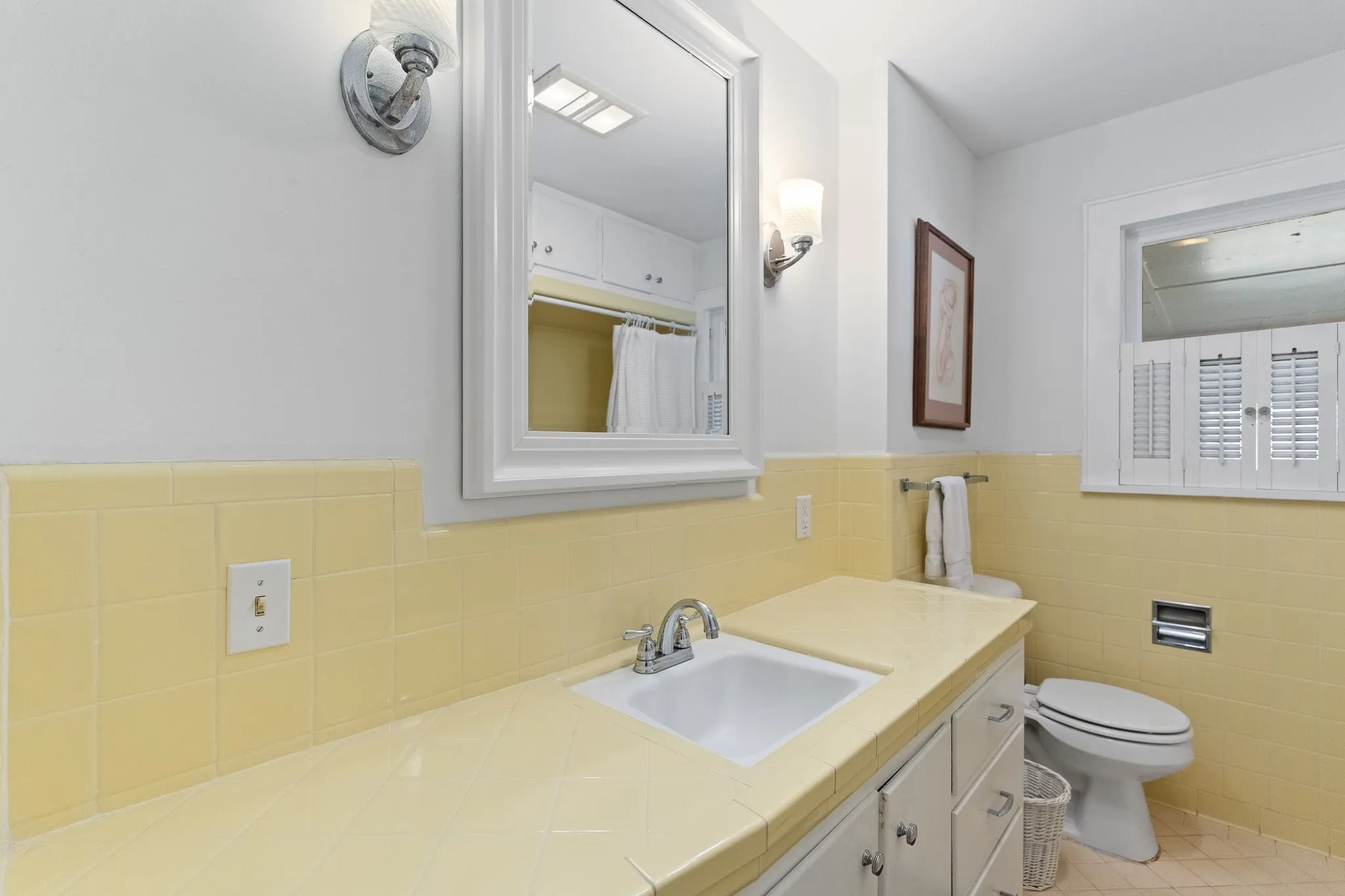 Here's the hall bathroom. Cute and TONS of cabinets!