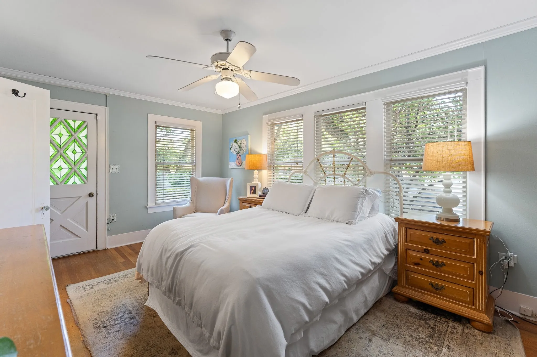 Here's the primary bedroom with tons of light. The cute door leads to the back yard.