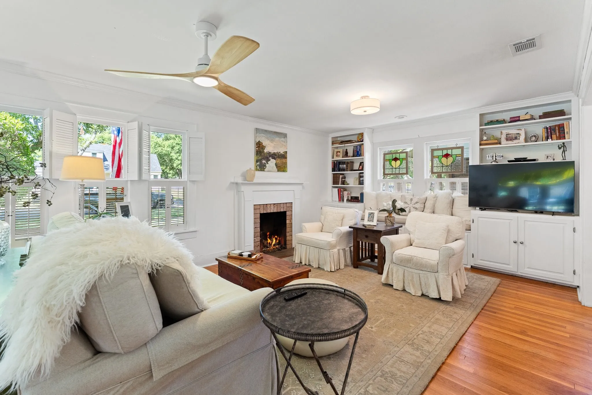 Such a cozy living room with built in bookshelves and a working gas fireplace. So much charm!