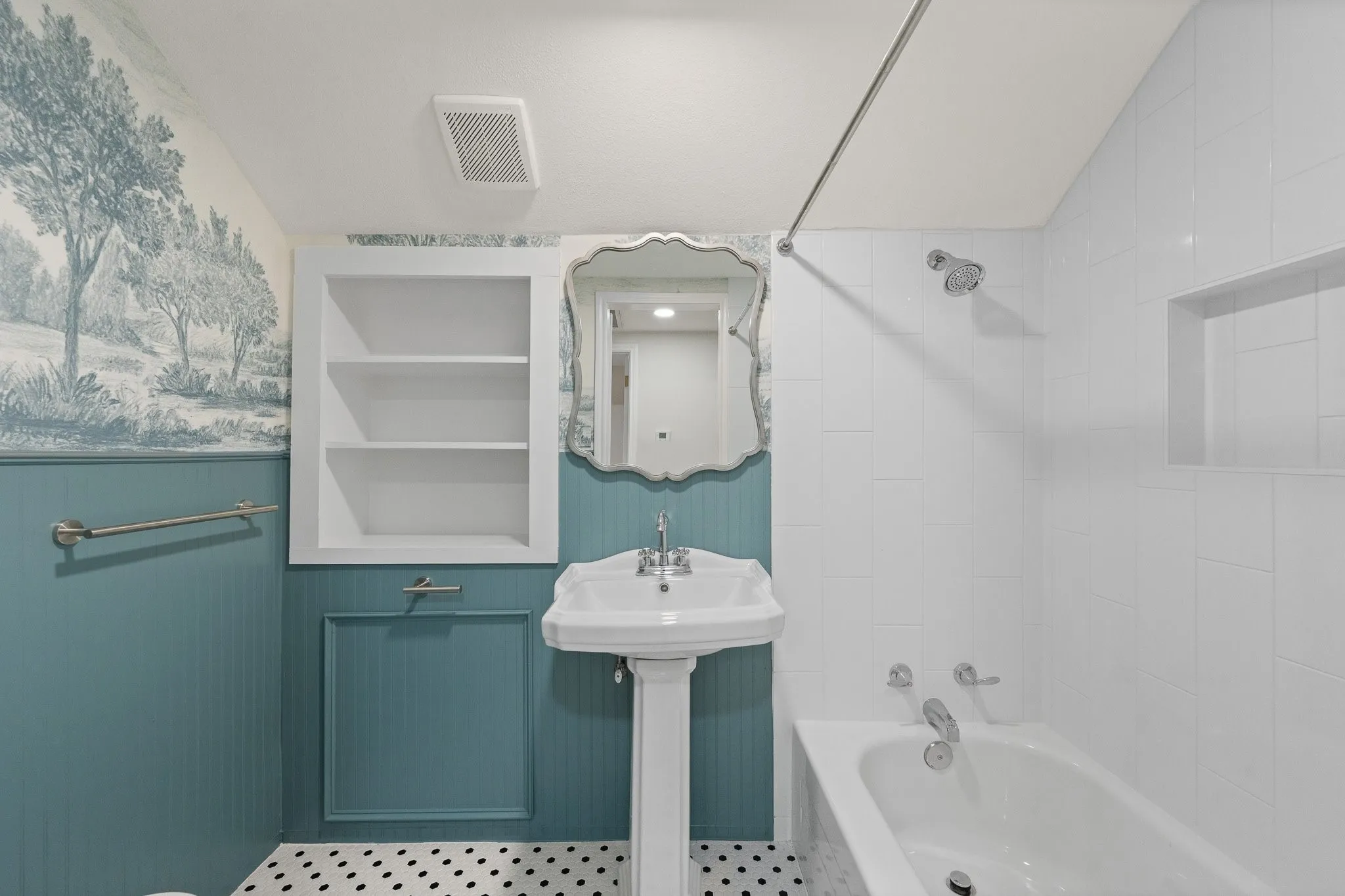 This is the upstairs bathroom. Totally renovated with custom wallpaper and all new tile!