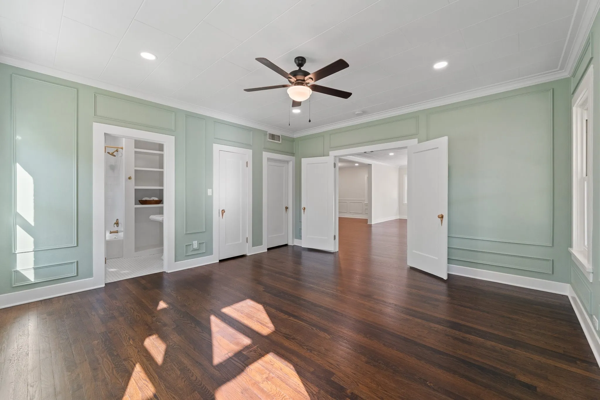 This room is off the main living area. It could be used as a second primary bedroom downstairs with ensuite or another living area or a large office suite.