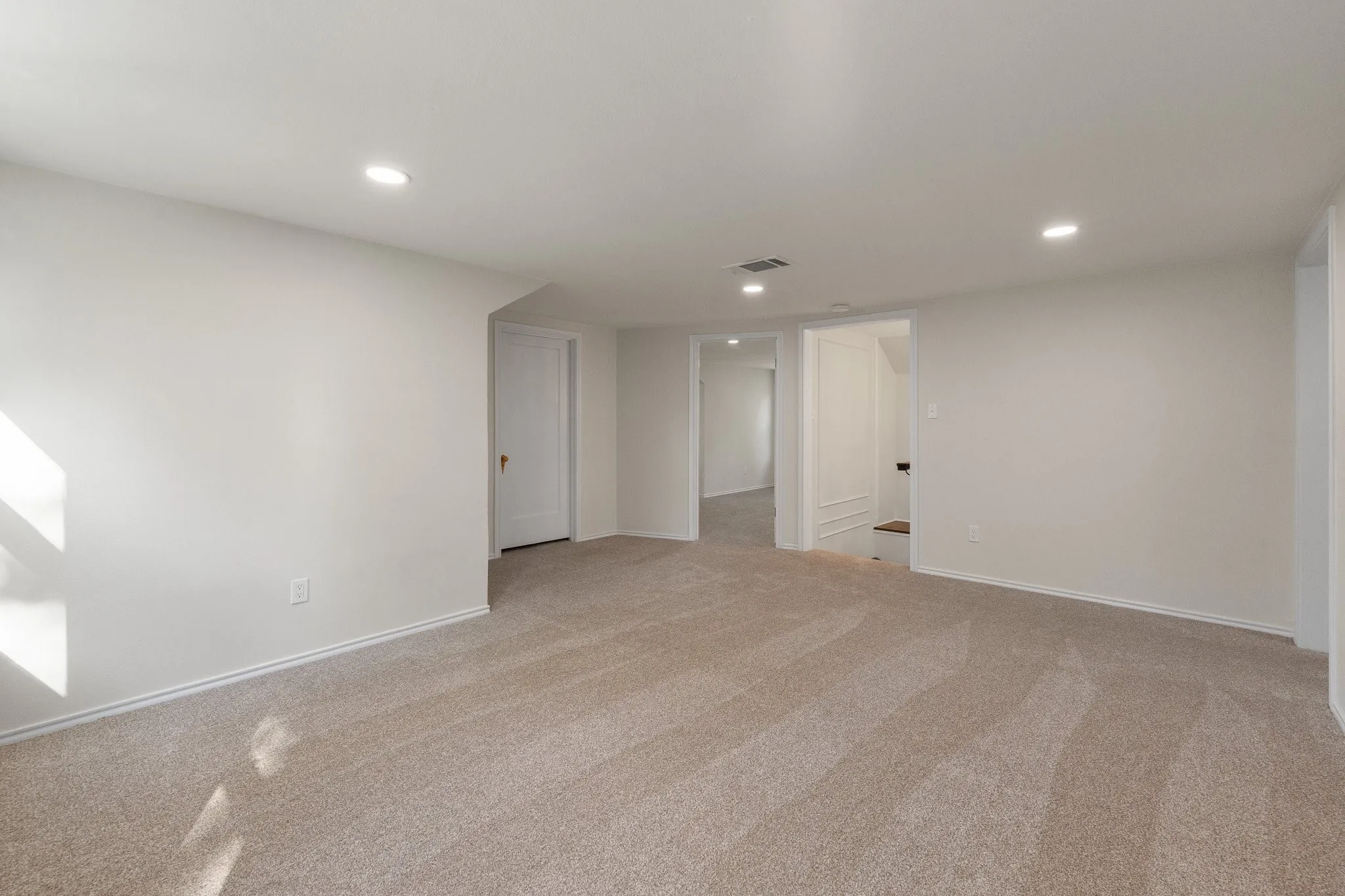This is the open den or family room or bonus room at the top of the stairs looking towards one of the upstairs bedrooms...the one with the balcony.