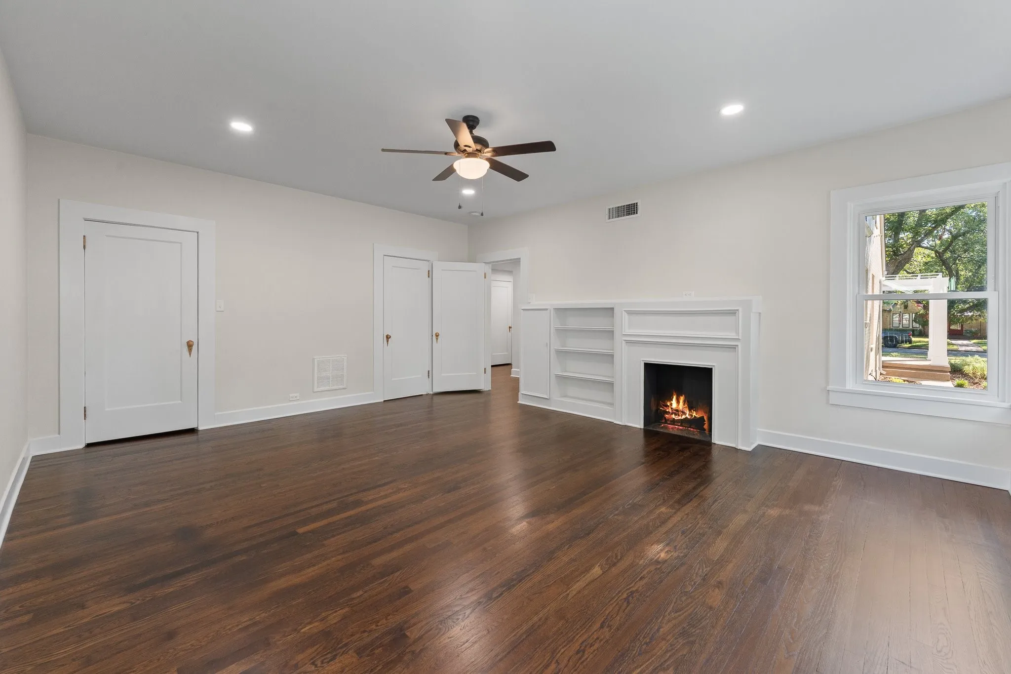 Here's another picture of the primary bedroom. The door on the left is the large walk in closet and the door on the irght is to the ensuite bathroom.