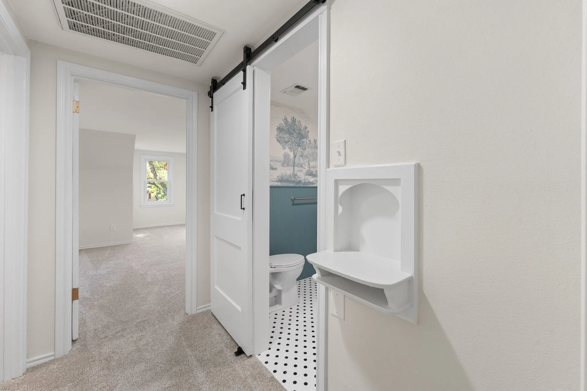 This is a look into the bathroom and looking straight into one of the upstairs bedrooms.