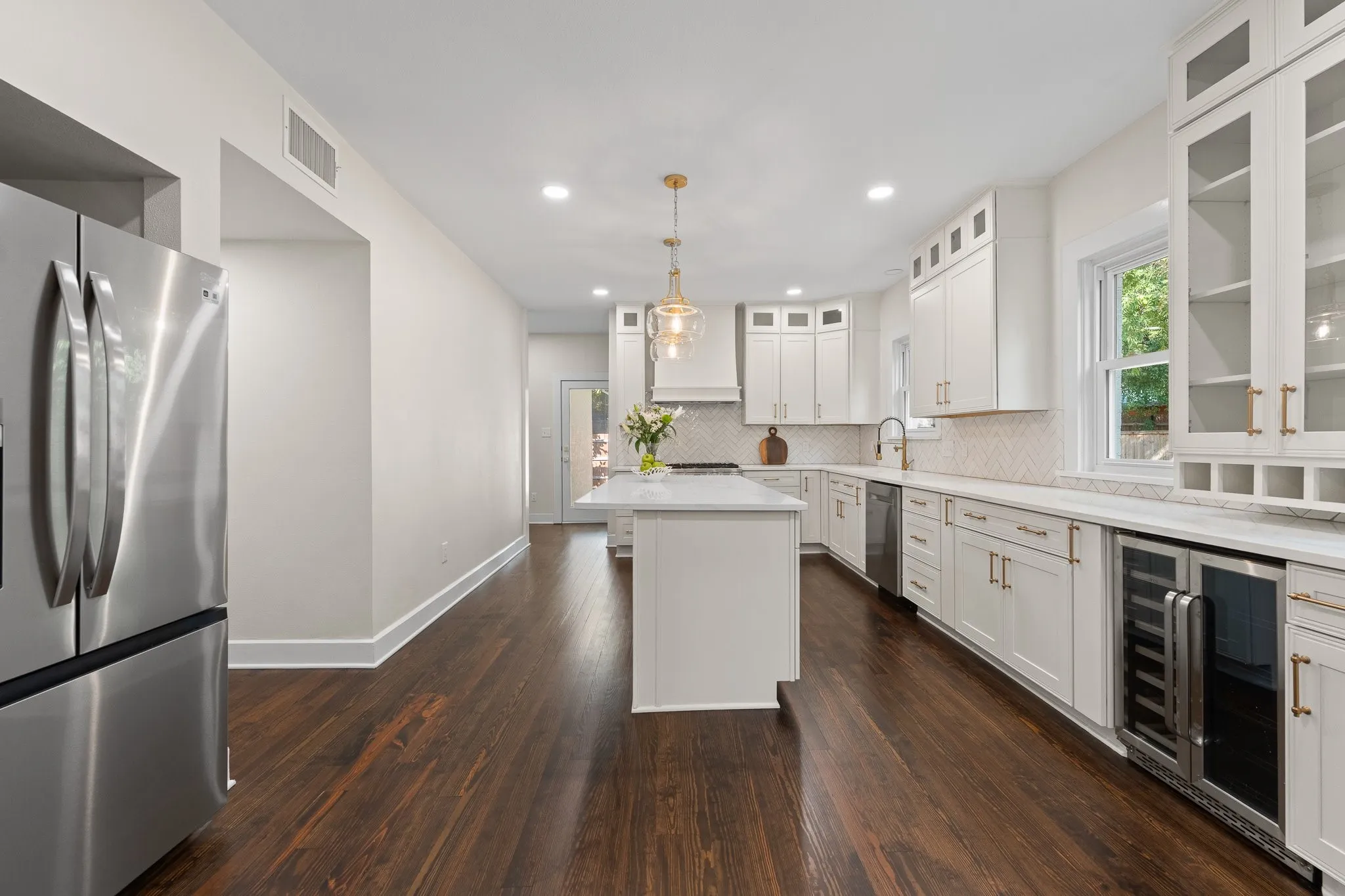 Is this kitchen gorgeous or what?! Check out the wine refrigerator, quartz countertops, recessed lighting and a NEW Thor 36"6 burner gas range with microwave door and a brand new refrigerator comes with the house, too!