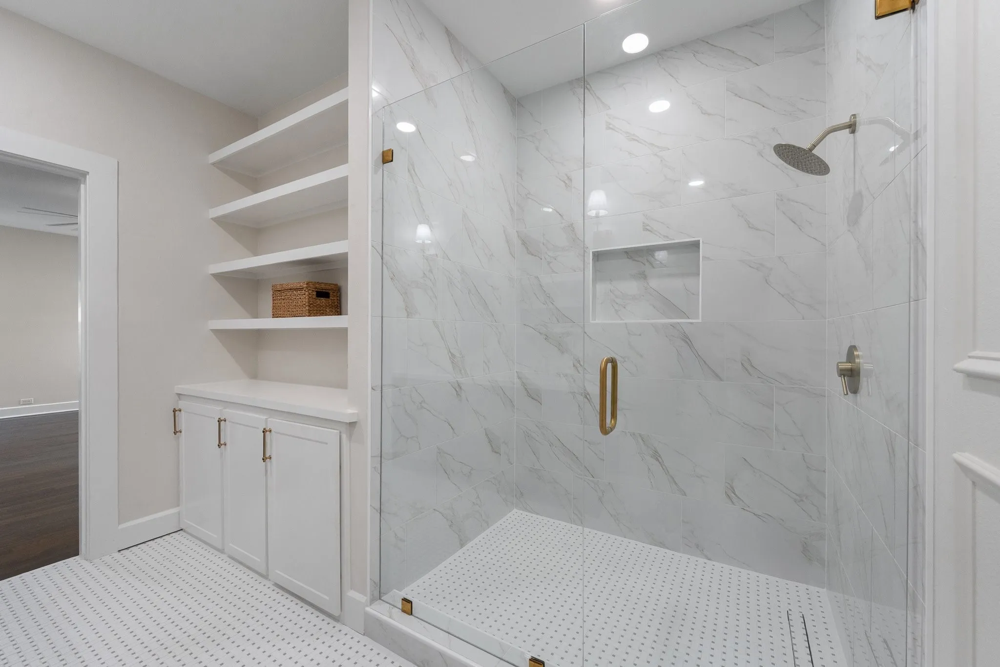 Gorgeous all-white shower with frameless glass doors. Stunning!
